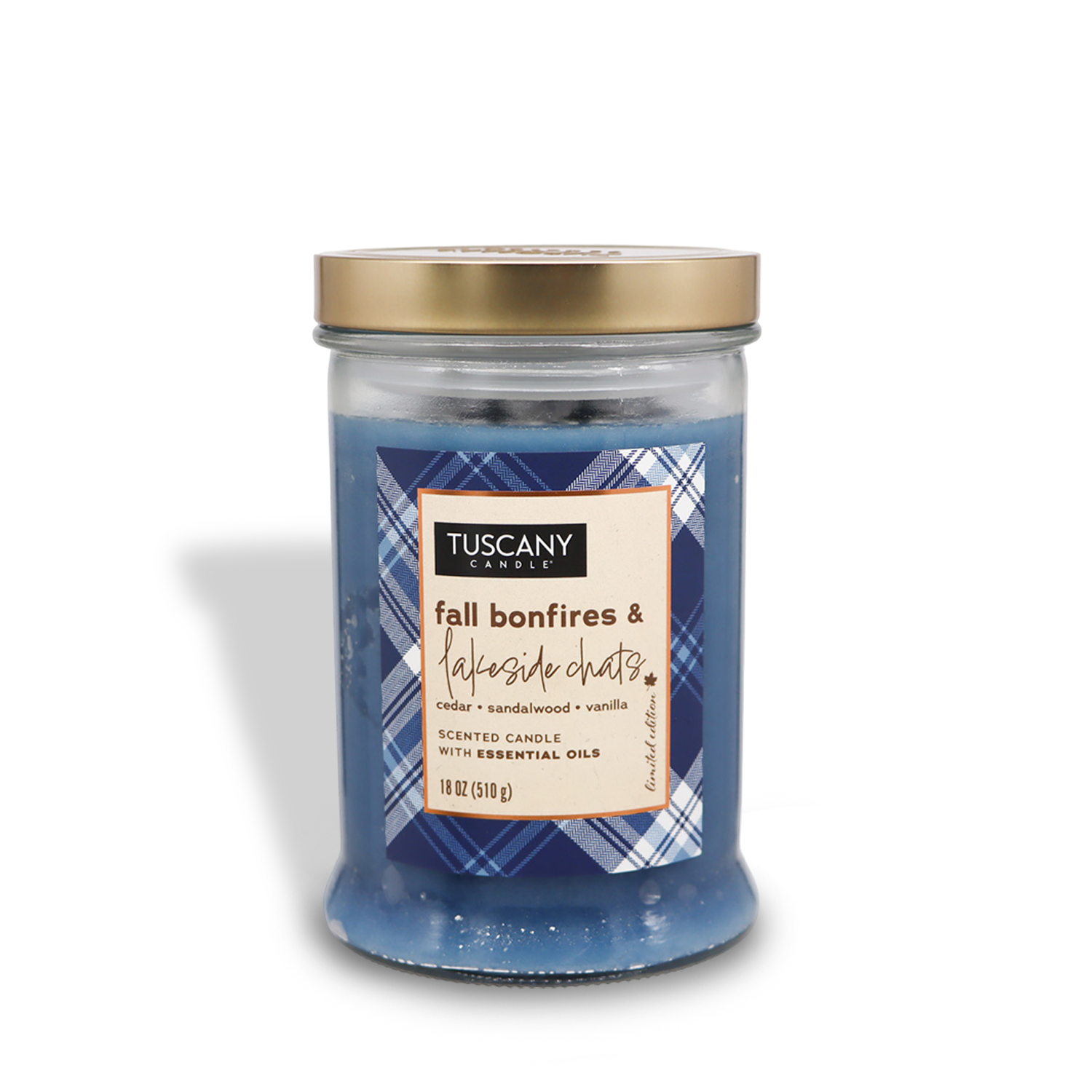 A jar of Tuscany Candle® SEASONAL from the Autumn Flannels Collection, featuring an 18 oz Fall Bonfires & Lakeside Chats long-lasting scented candle with a gold lid. The label reads "fall bonfires & lakeside chats" and it comes in blue, evoking scents of cedar, sandalwood, vanilla, and infused with essential oils.