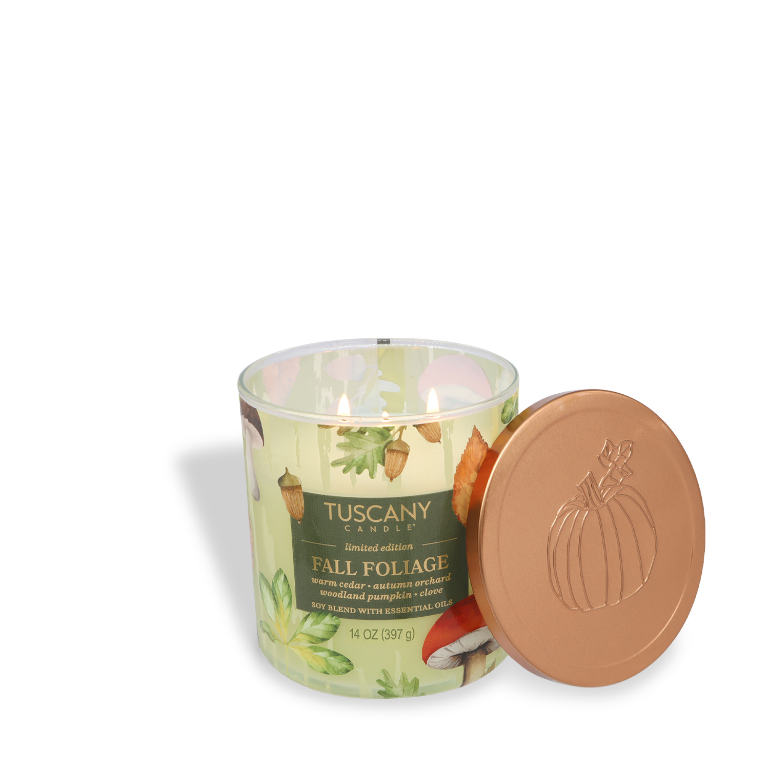 A Tuscany Candle® SEASONAL Fall Foilage: Pumpkin & Cedar Scented Fall Candle (14 oz) from the Simply Fall Collection sits in a glass jar labeled "Fall Foliage," with a bronze pumpkin-embossed lid beside it.