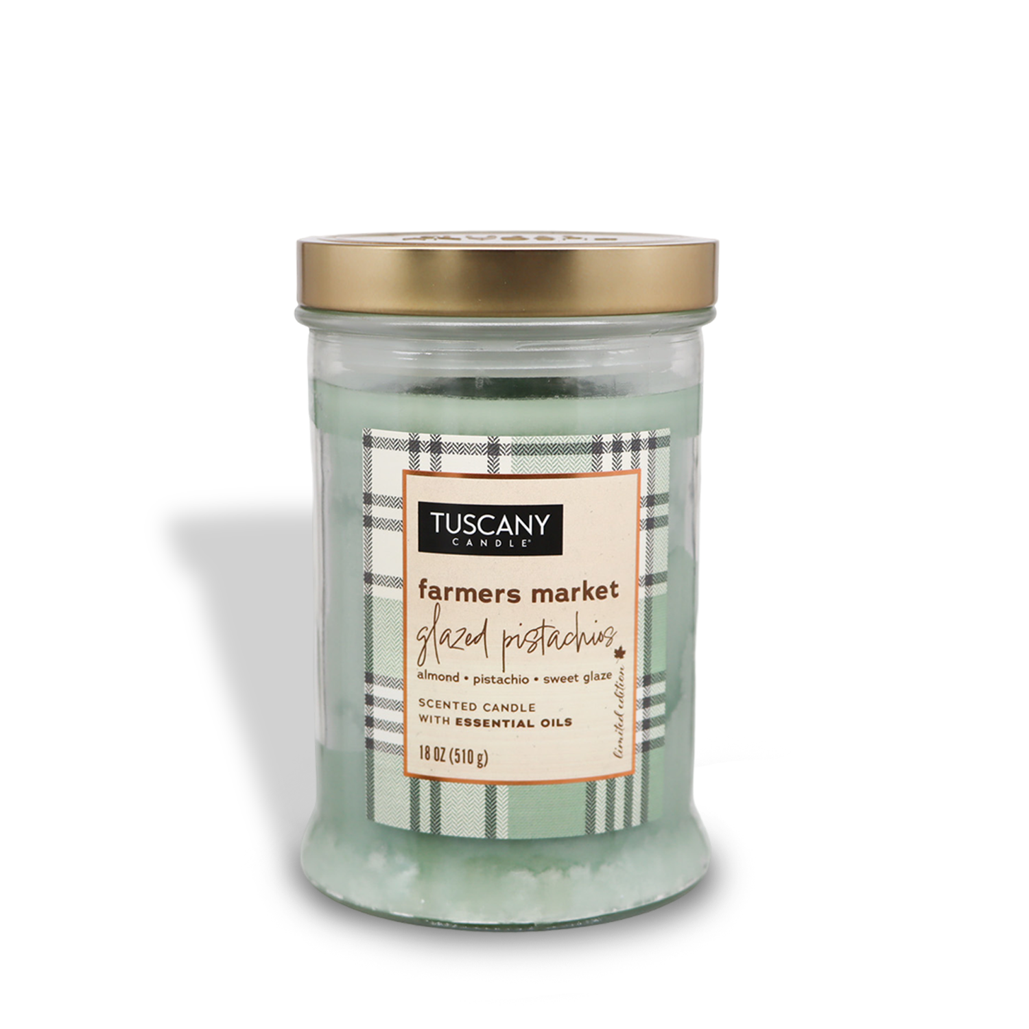 An 18 oz. Farmers Market Glazed Pistachios Long-Lasting Scented Jar Candle from the Autumn Flannels Collection by Tuscany Candle® SEASONAL, featuring almond, pistachio, and sweet glaze scents with essential oils, in a clear glass jar with a gold lid and premium satin wax.