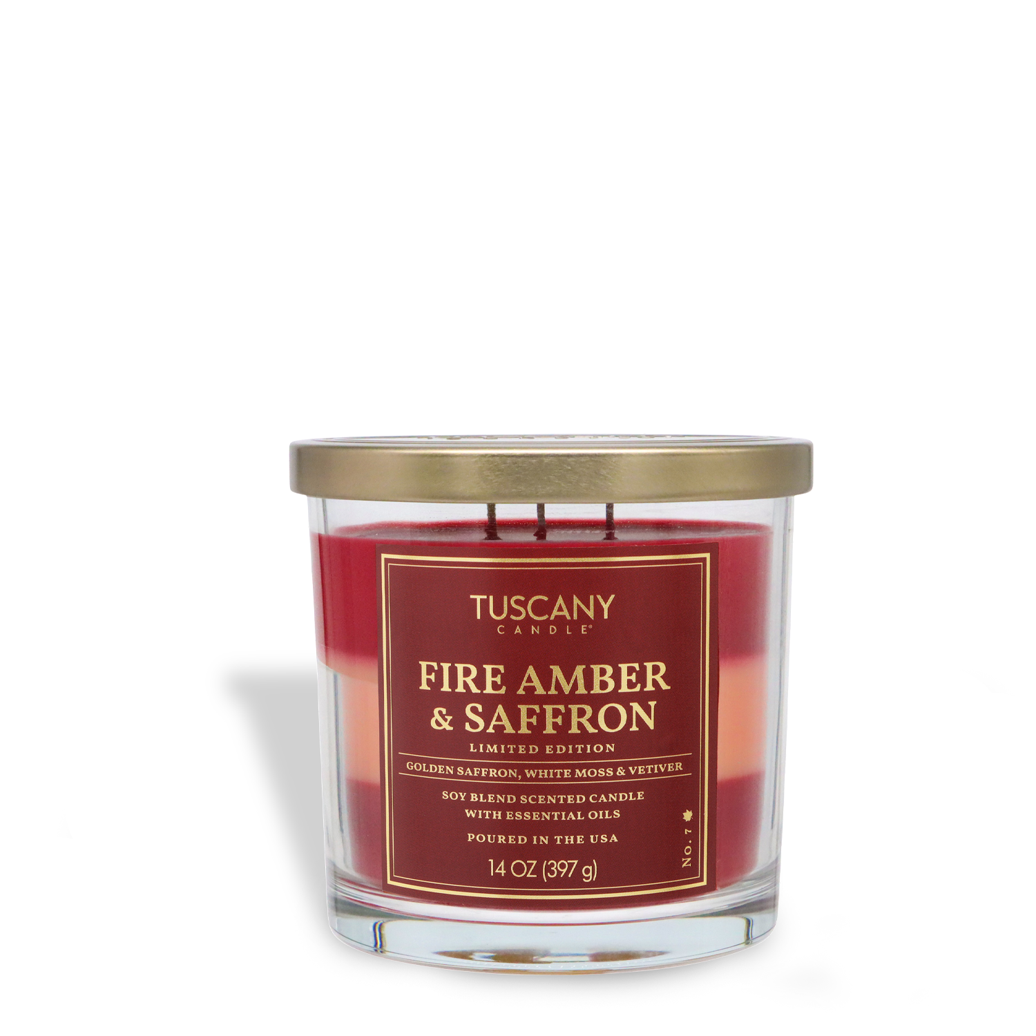 A 14 oz Tuscany Candle® SEASONAL "Fire Amber & Saffron: Vetiver & Moss" fall candle in a clear glass jar with gold lid, soy blend scented.