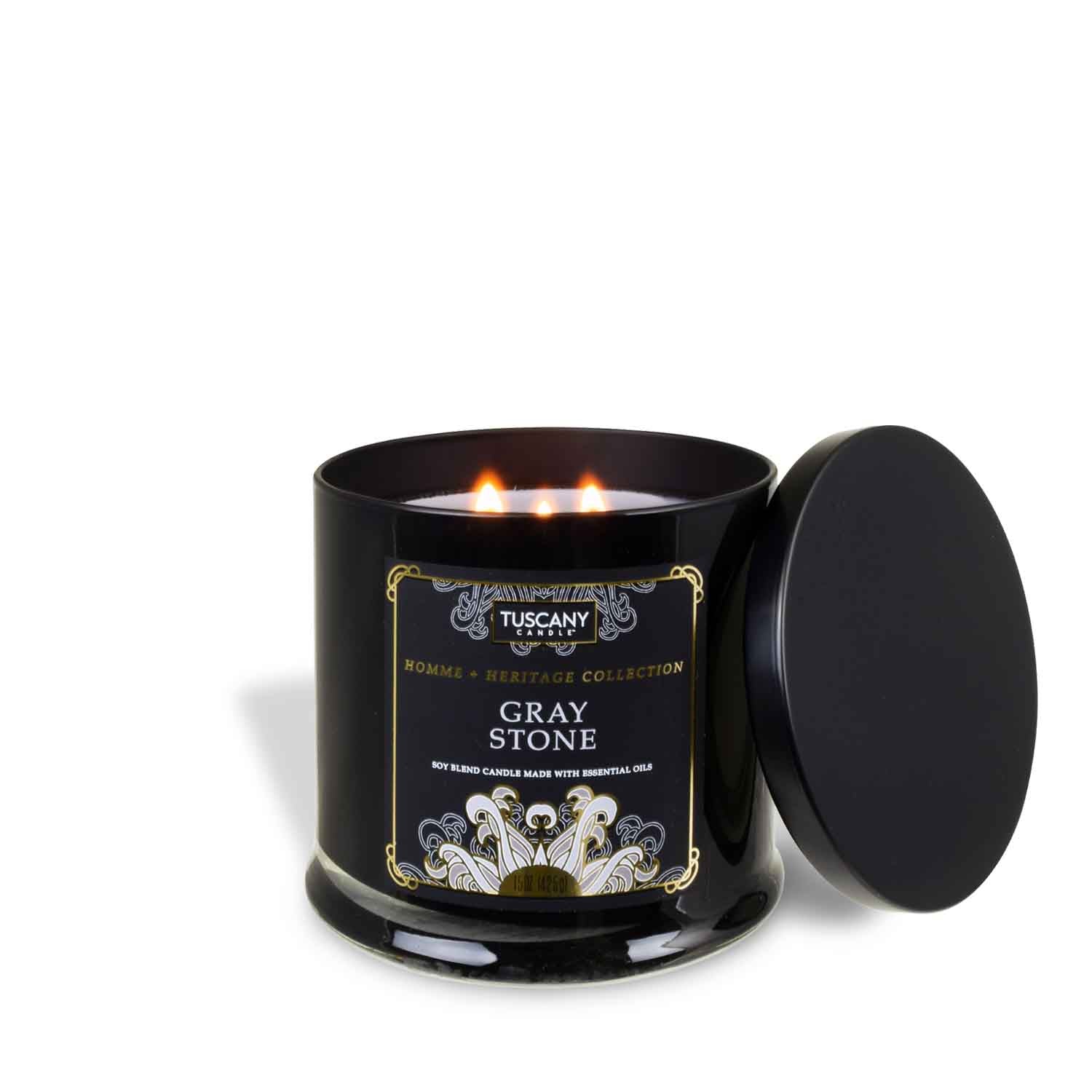 A Gray Stone scented jar candle with a gold lid, from the Homme + Heritage collection by Tuscany Candle.