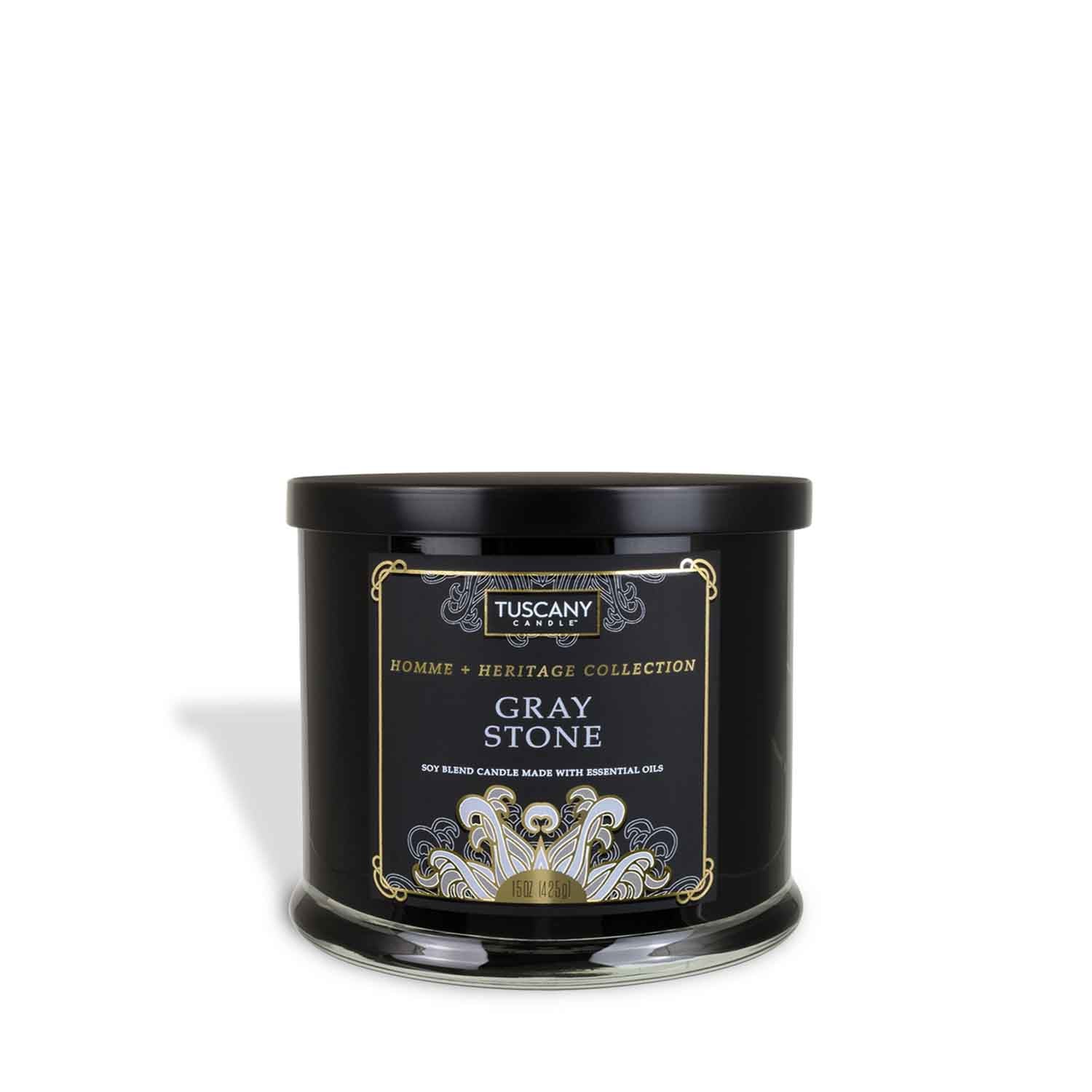 A Gray Stone scented jar candle (15 oz) from the Homme + Heritage collection by Tuscany Candle, featuring essential oils and fragrant notes, placed on a clean white background.