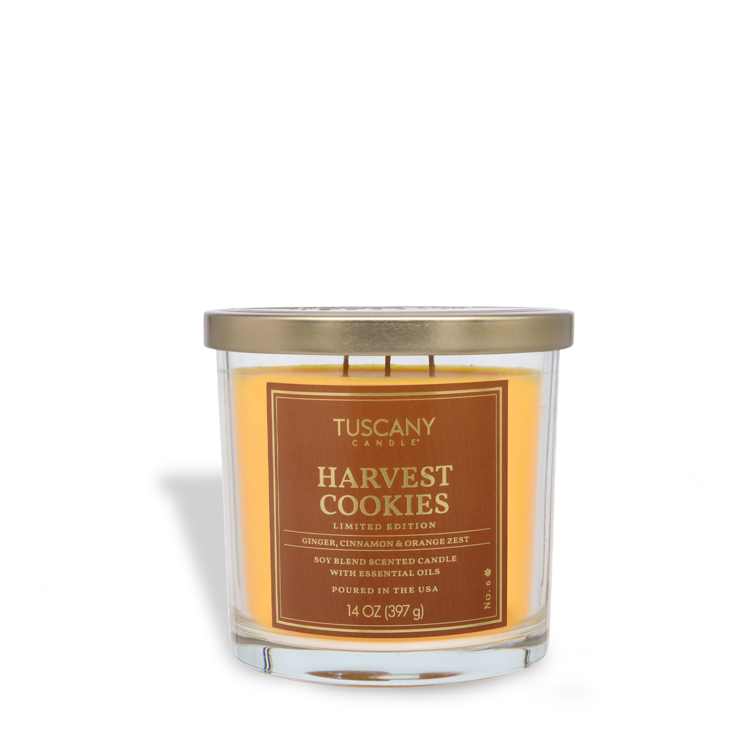 A 14 oz glass jar candle labeled "Harvest Cookies: Brown Sugar & Vanilla Scented Fall Candle" by Tuscany Candle® SEASONAL, featuring orange wax and a gold lid.