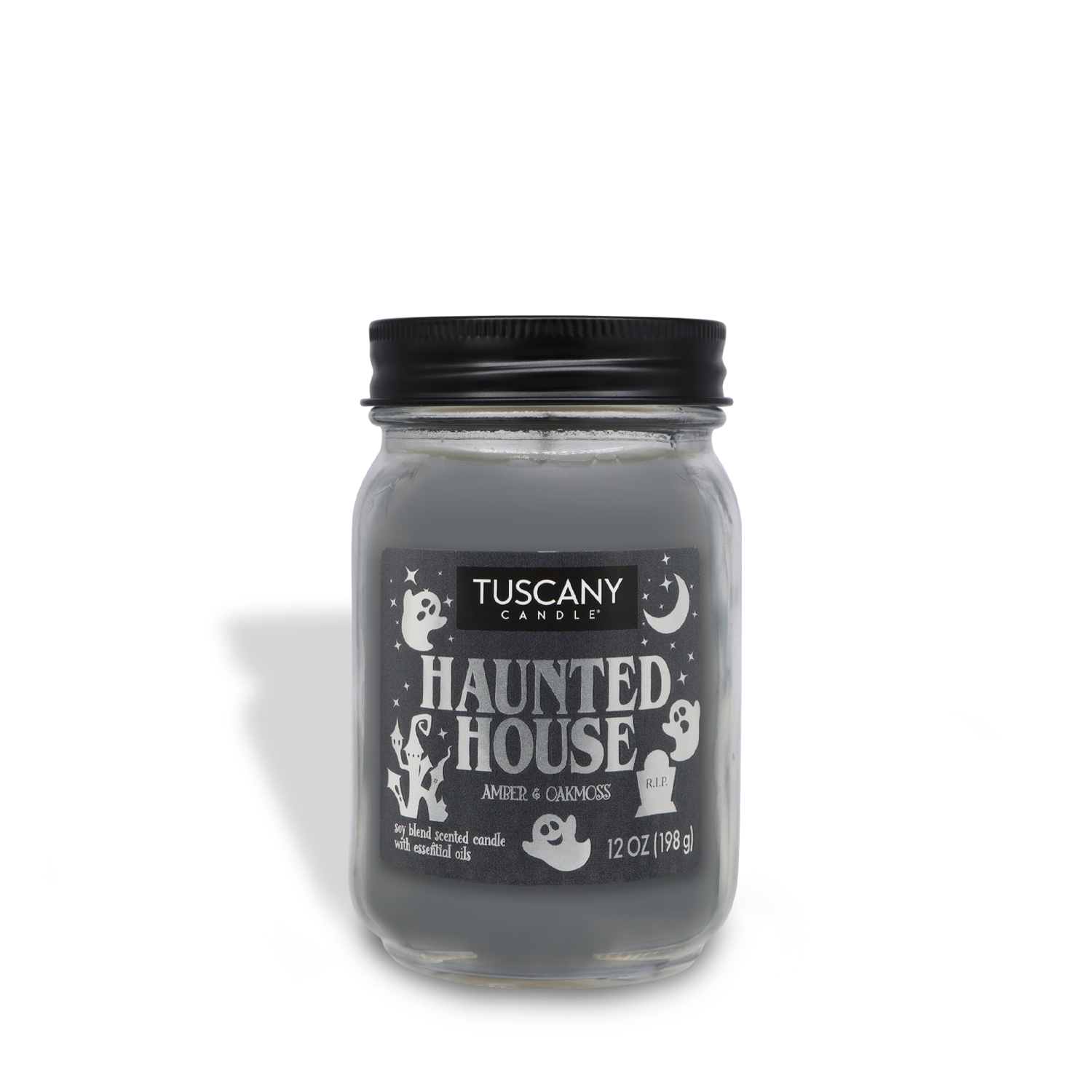 A jar candle labeled "Tuscany Candle® SEASONAL - Haunted House Long-Lasting Scented Jar Candle (12 oz)" featuring an amber and oakmoss scent. The jar, part of a limited-run collection, is decorated with ghost and moon illustrations and contains 12 oz (198 g) of premium satin wax in grey.