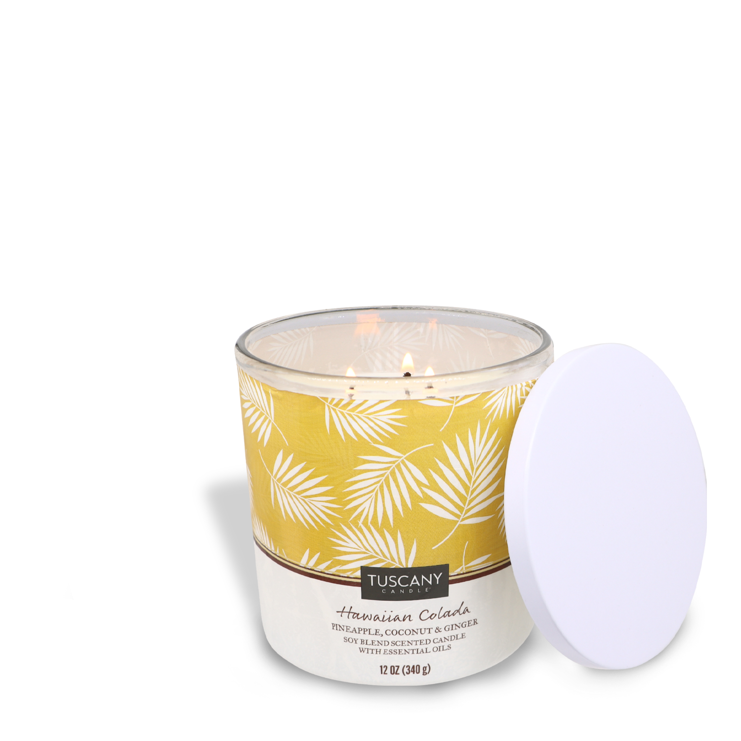 A Hawaiian Colada scented candle with a tropical design label and its lid placed beside it. (Tuscany Candle® SEASONAL)