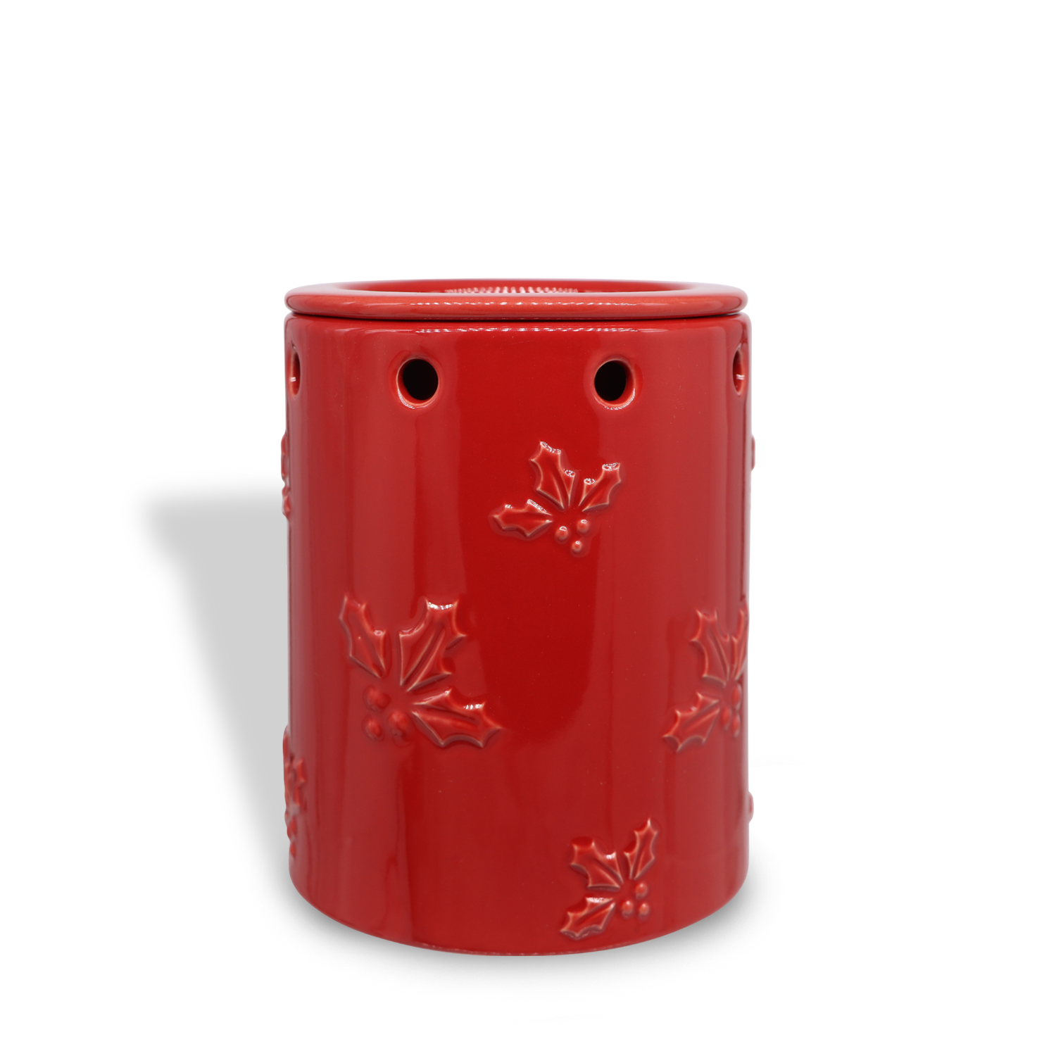 Holly Leaf Wax Melt Warmer by Tuscany Candle® SEASONAL, featuring a red ceramic design with holly leaf patterns and circular cutouts.