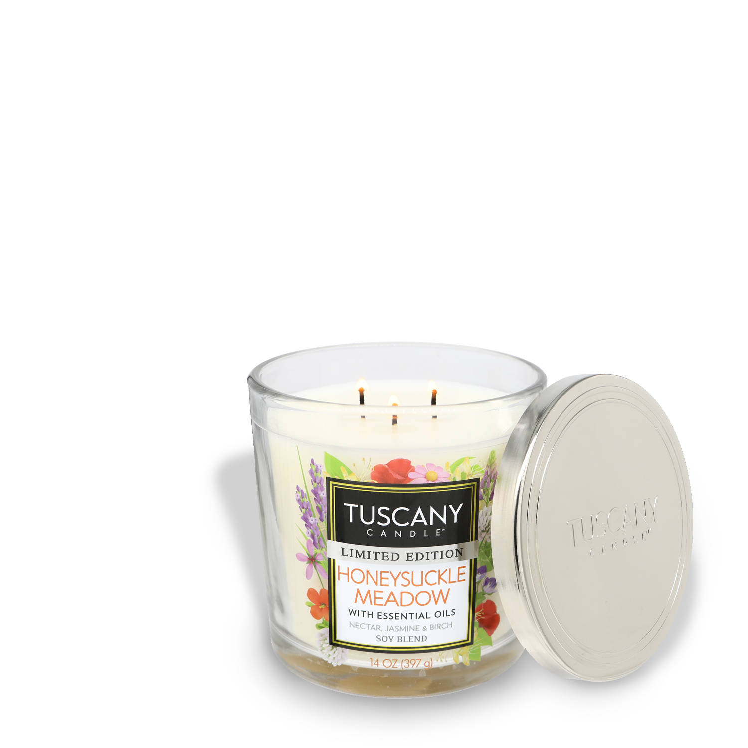 A three-wick Honeysuckle Meadow scented candle in a glass jar with a metallic lid off to the side, labeled "Tuscany Limited Edition Cherry Blossom Meadow with Essential Oils.