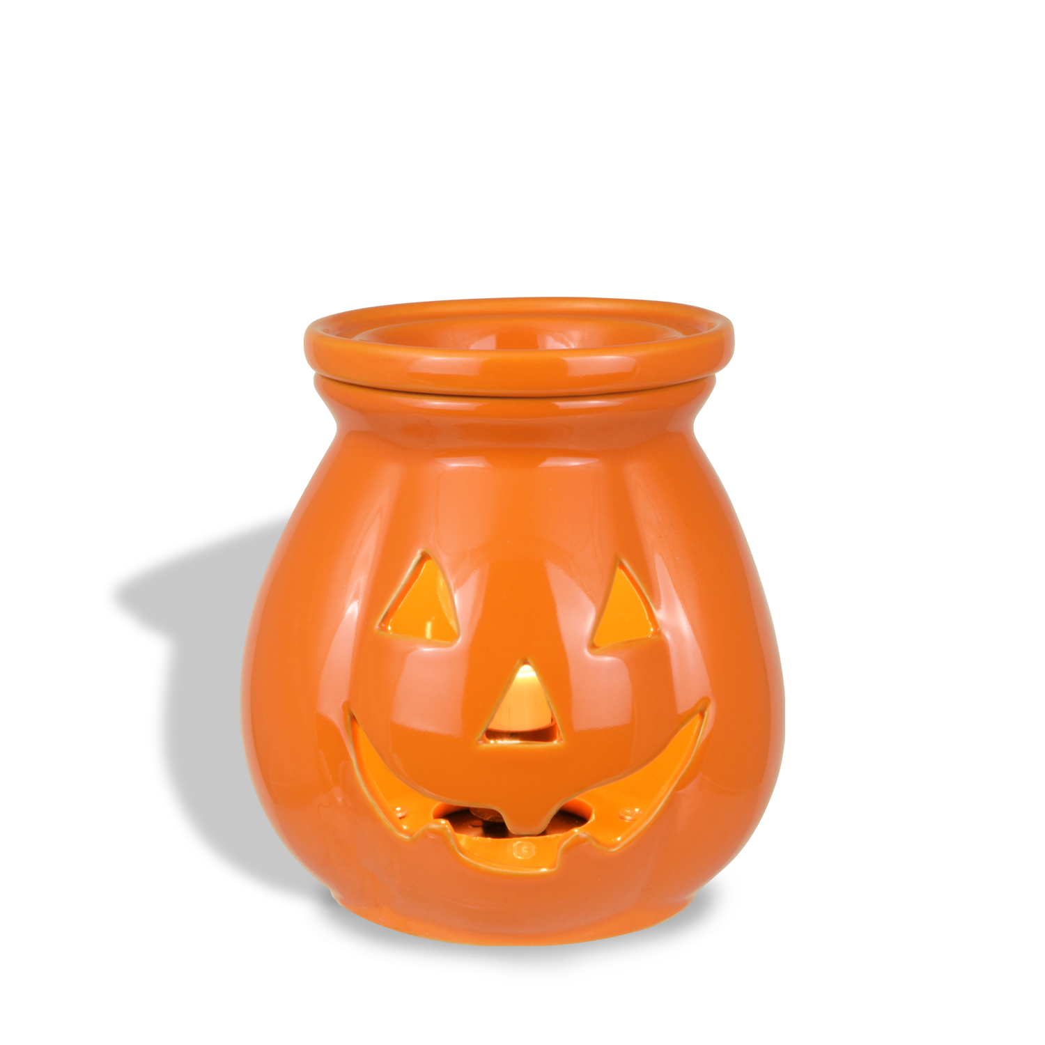 An orange ceramic Jack O' Lantern Wax Melt Warmer by Tuscany Candle® SEASONAL with a carved smiling face and triangular eyes and nose features a low wattage light bulb to gently illuminate your space. Perfect for celebrating the season, this piece adds whimsical charm to any room.