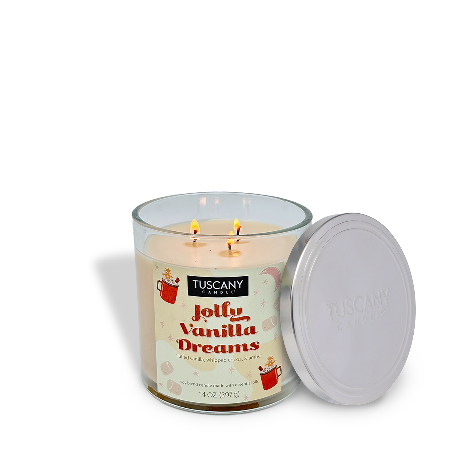 A Tuscany Candle® SEASONAL Jolly Vanilla Dreams Scented Holiday Candle, 14 oz, features three lit wicks in a glass jar with a white lid placed beside it.