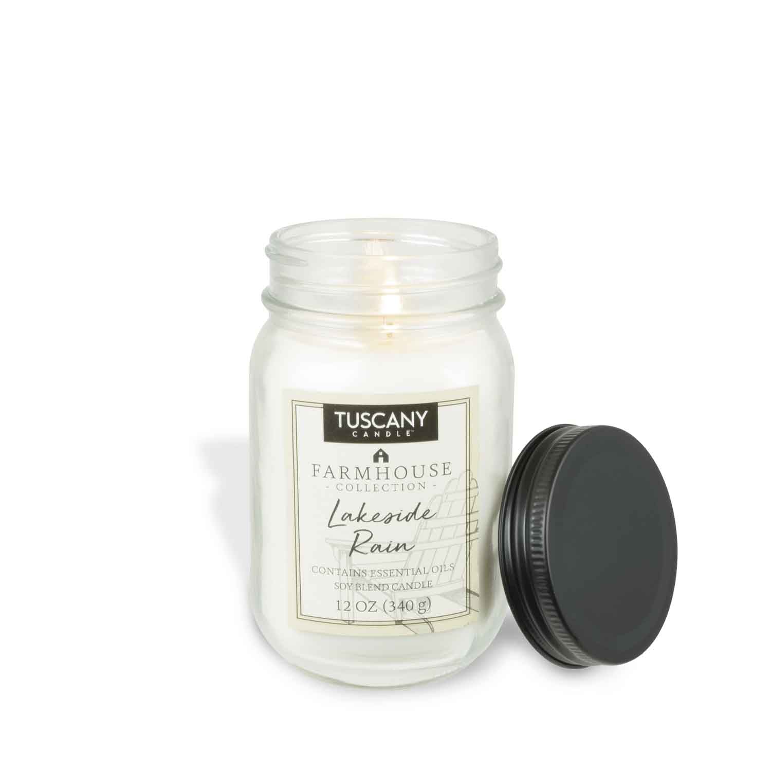 A Lakeside Rain scented candle from the Tuscany Candle® EVD Farmhouse Collection, encased in a white jar.