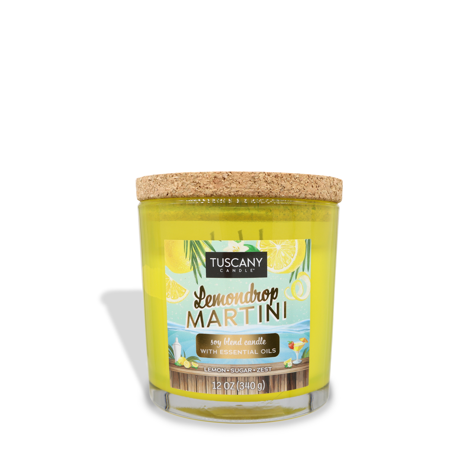 Yellow candle in a clear glass jar with a cork lid labeled "Tuscany Candle® SEASONAL, Lemondrop Martini (12 oz) – Sunset Beach Bar Collection, soy blend candle with essential oils." The 12 oz. scented jar candle features a label adorned with lemons and leaves, evoking the refreshing aroma of lemon zest and sugar.
