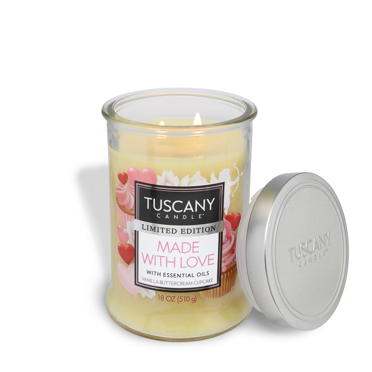 A Tuscany Candle® SEASONAL product, the "Made With Love: Vanilla Scented Valentine’s Day Candle" in an 18 oz glass jar, infuses the environment with the delightful aroma of buttercream frosting. Accompanied by a sleek silver lid resting gracefully beside it, this candle is ideal for creating a romantic Valentine's Day atmosphere.