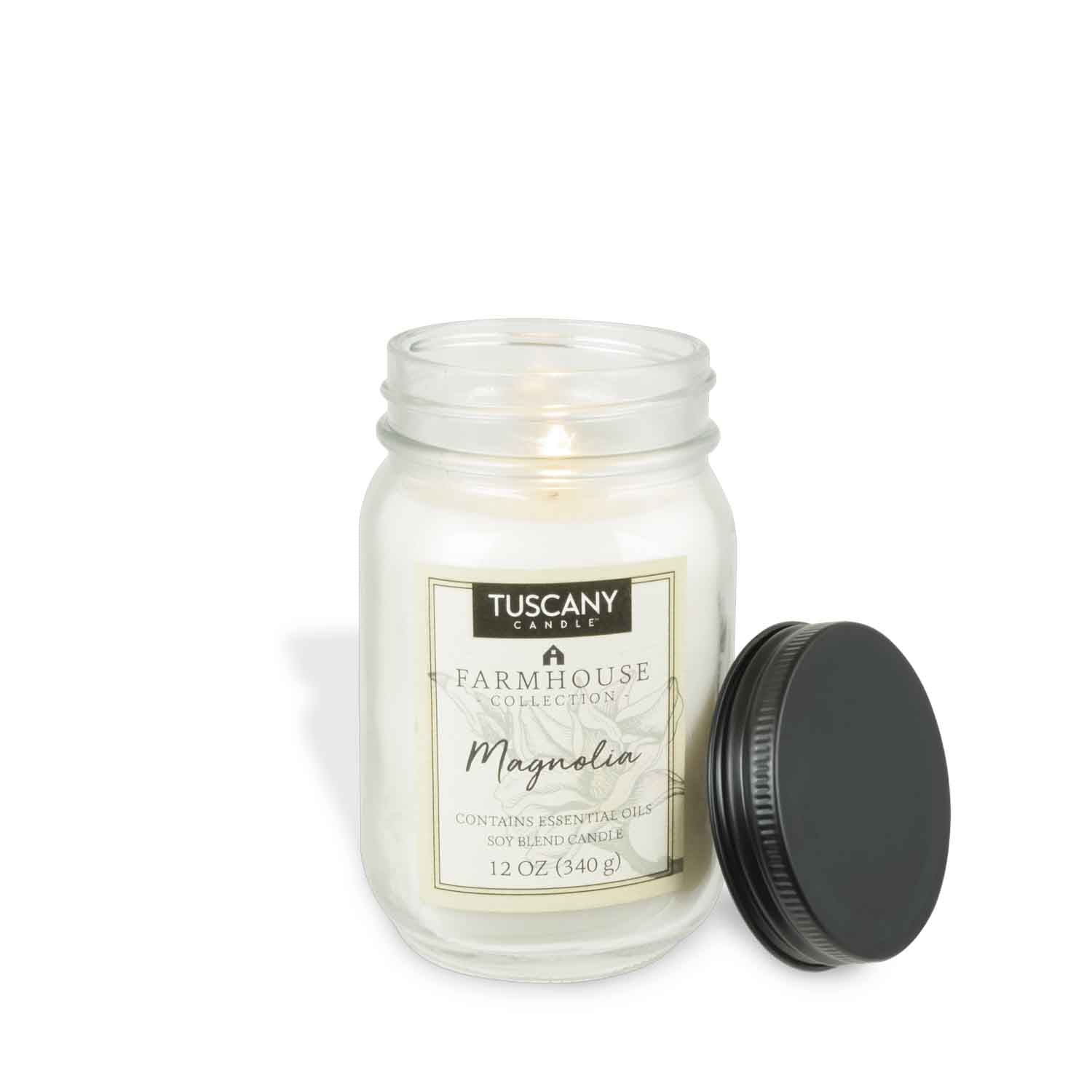 Clear mason jar candle with black lid, containing a 12oz scented candle named 'Magnolia' from our Farmhouse collection.