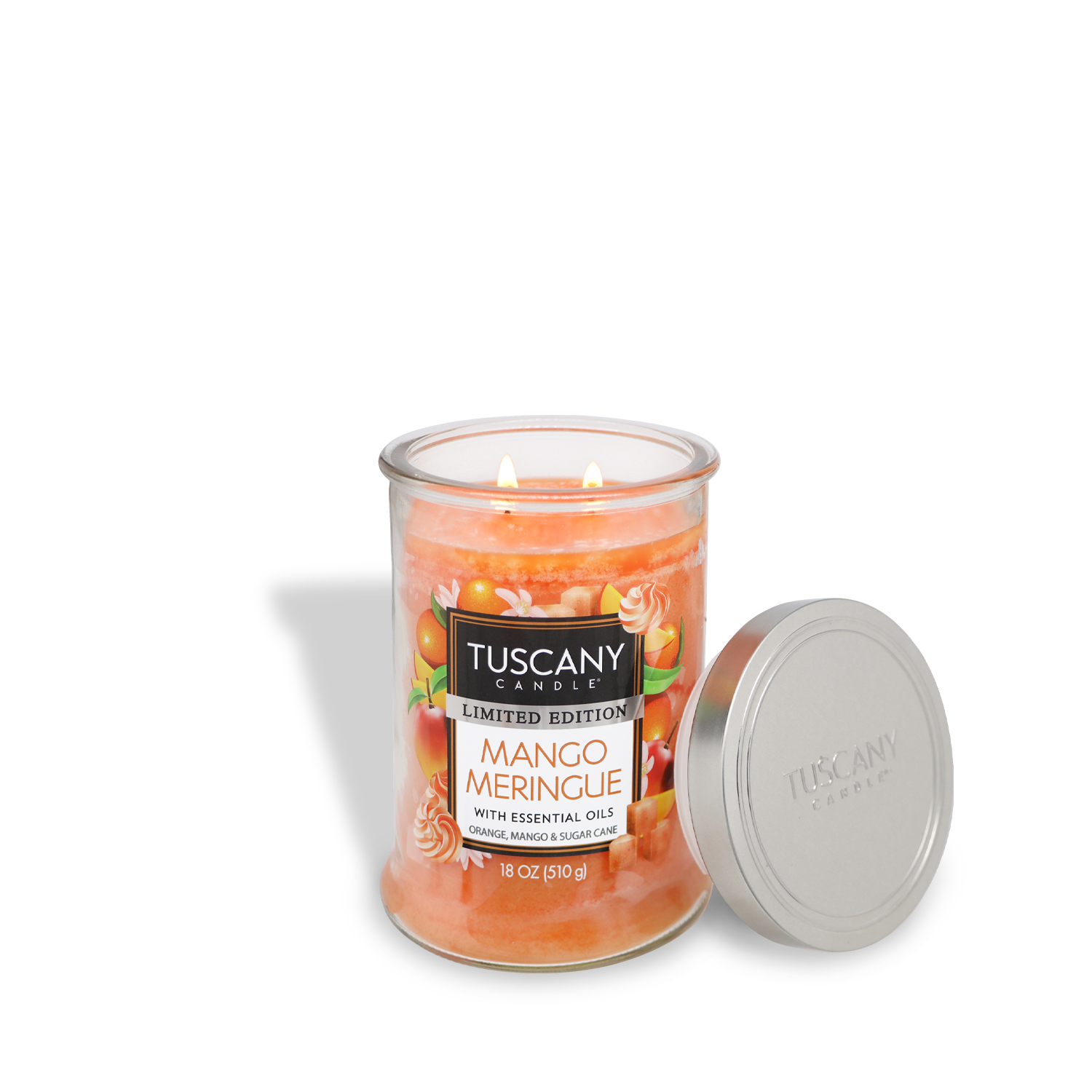 A lit Tuscany Candle® SEASONAL Mango Meringue, Sweet Orange Scented Spring Candle (18 oz) with two flames, in a glass jar and an open metal lid beside it. The candle is orange.