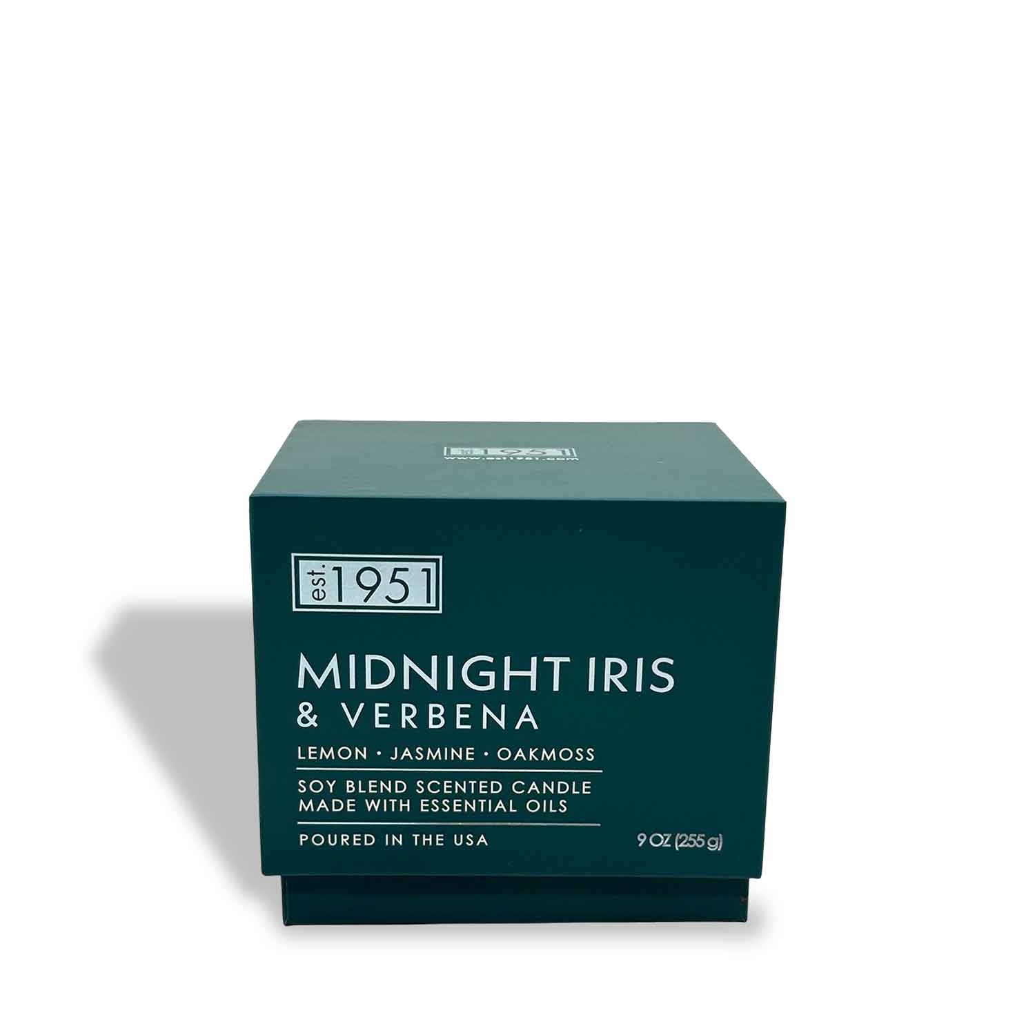 A teal box labeled "Midnight Iris & Verbena (9oz)" by est.1951, this floral candle blends lemon, jasmine, oakmoss, and essential oils in a clean-burning soy wax for a fresh fragrance experience.