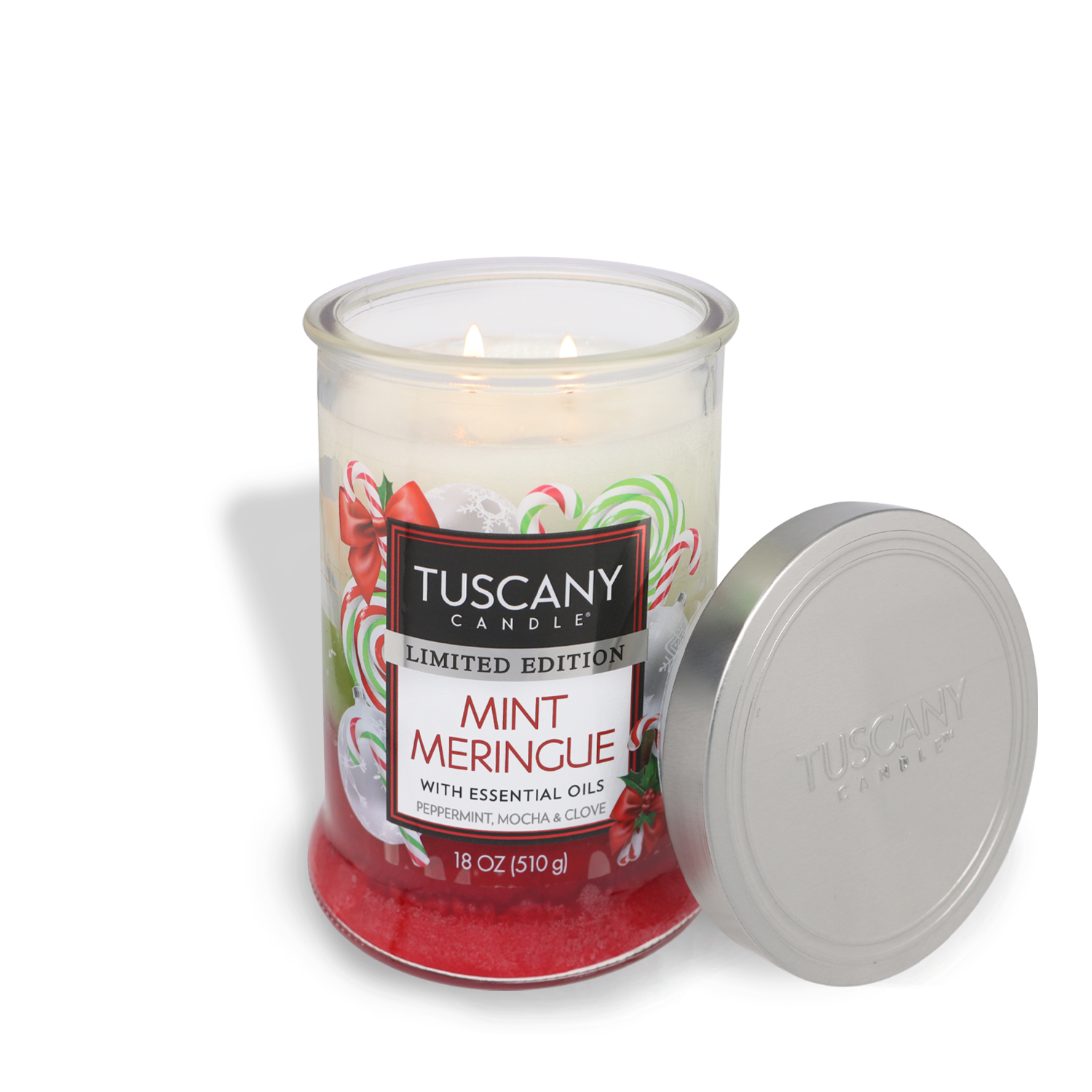 A lit Mint Meringue Long-Lasting Scented Jar Candle (18 oz) by Tuscany Candle® SEASONAL with essential oils, featuring peppermint, mocha, and clove scents. The lid is placed beside the jar.