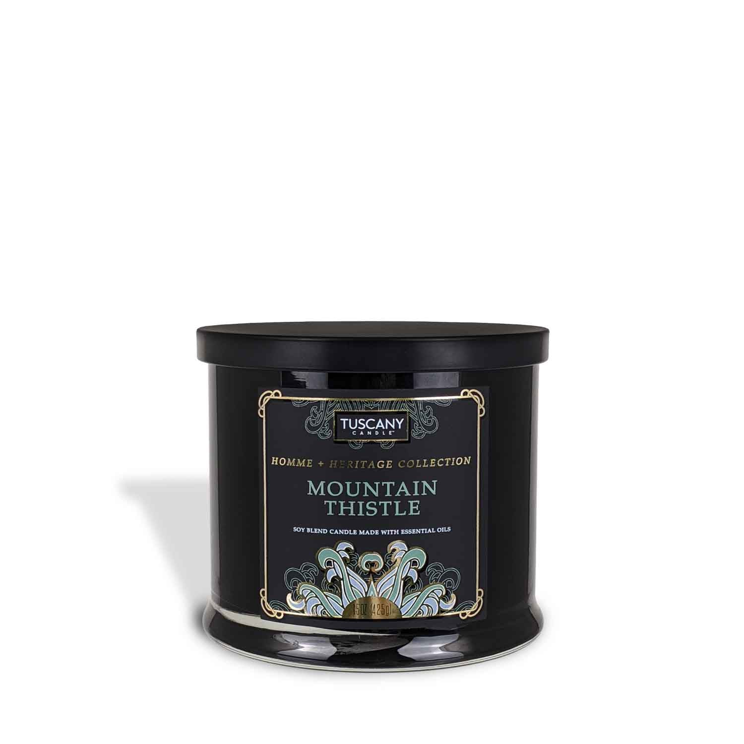 A black tin Mountain Thistle Scented Jar Candle (15 oz) – Homme + Heritage Collection by Tuscany Candle with the words "mountain white" on it, featuring essential oils from our fragrances collection.