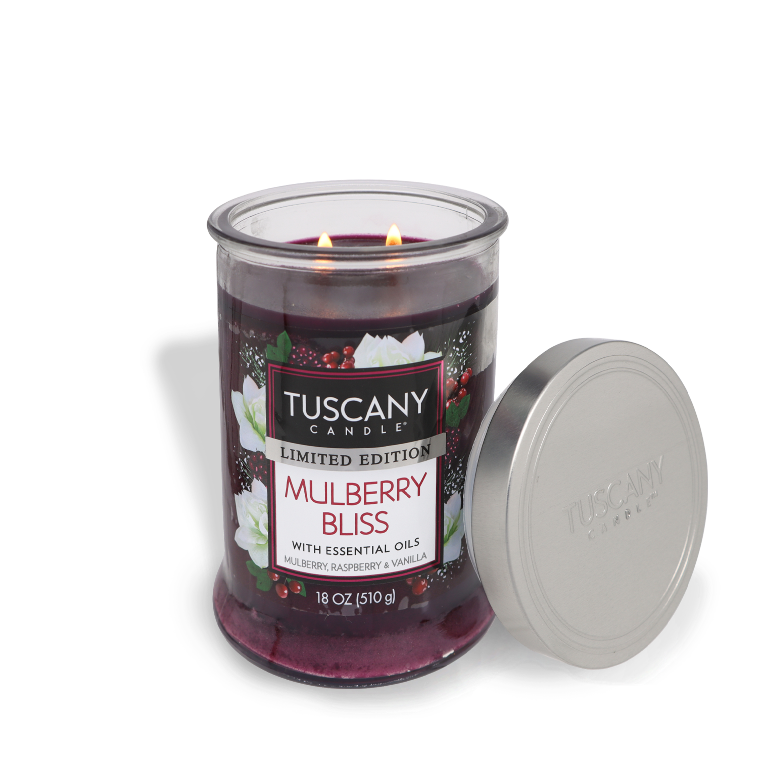 A lit Tuscany Candle® SEASONAL "Mulberry Bliss Long-Lasting Scented Jar Candle" in an 18 oz jar with essential oils, and the candle's lid placed on the side.