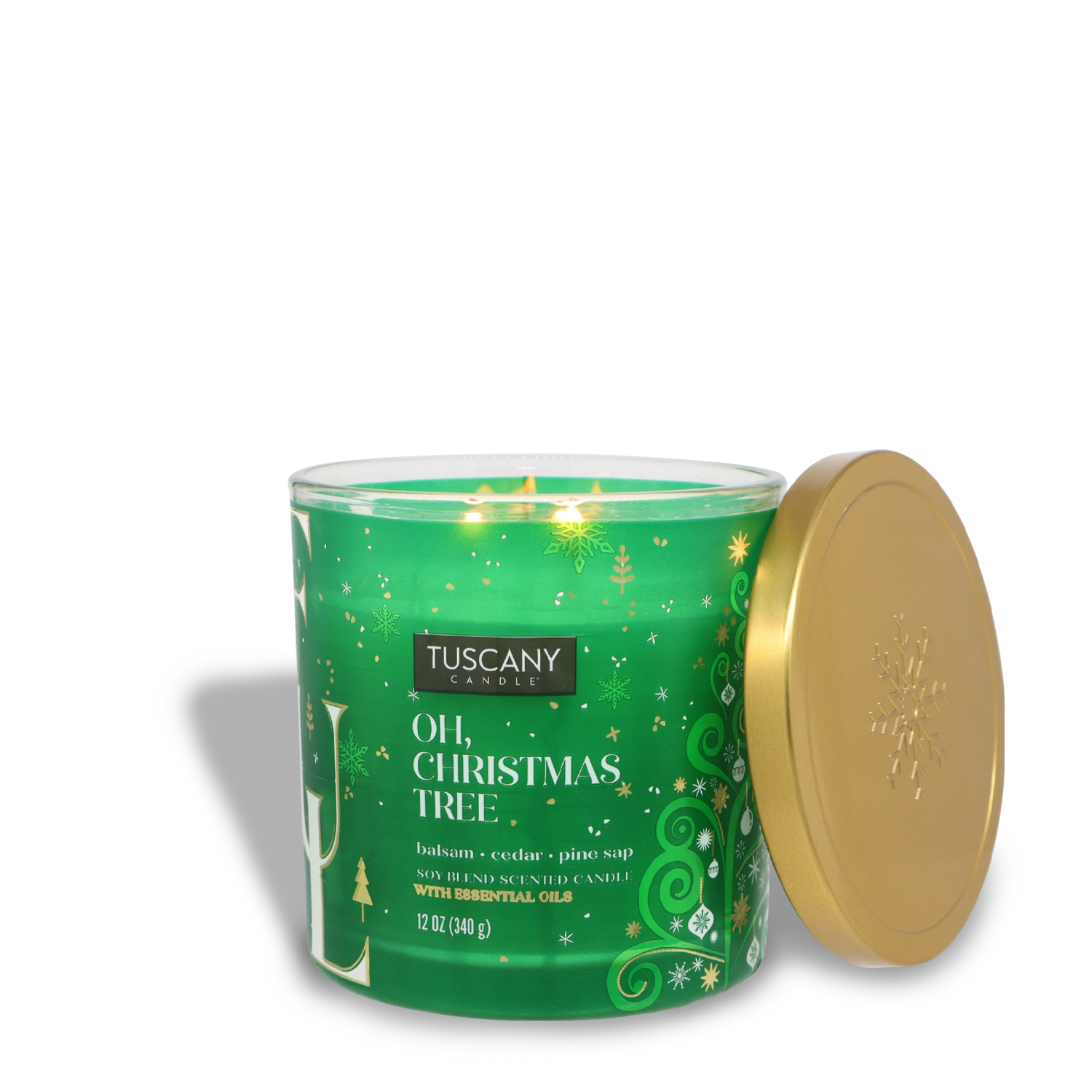 A lit green candle with the label "Oh, Christmas Tree" by Tuscany Candle® SEASONAL, accompanied by a gold lid on the side.