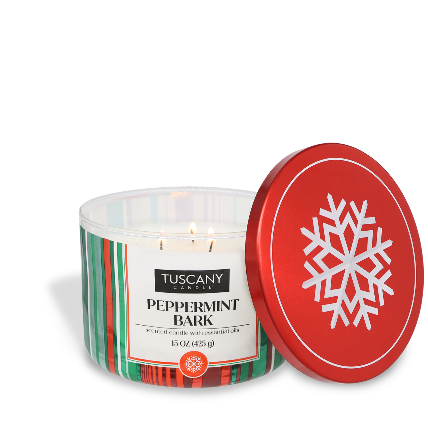 A Tuscany Candle® SEASONAL "Peppermint Bark Scented Jar Candle" with a red lid featuring a white snowflake pattern, 15 oz, open and lit with three flames.