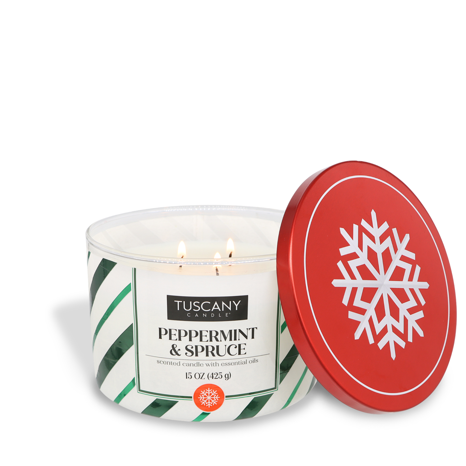 A lit Tuscany Candle® SEASONAL Peppermint & Spruce Scented Jar Candle (15 oz), accompanied by a red lid adorned with a white snowflake design, resting beside it.