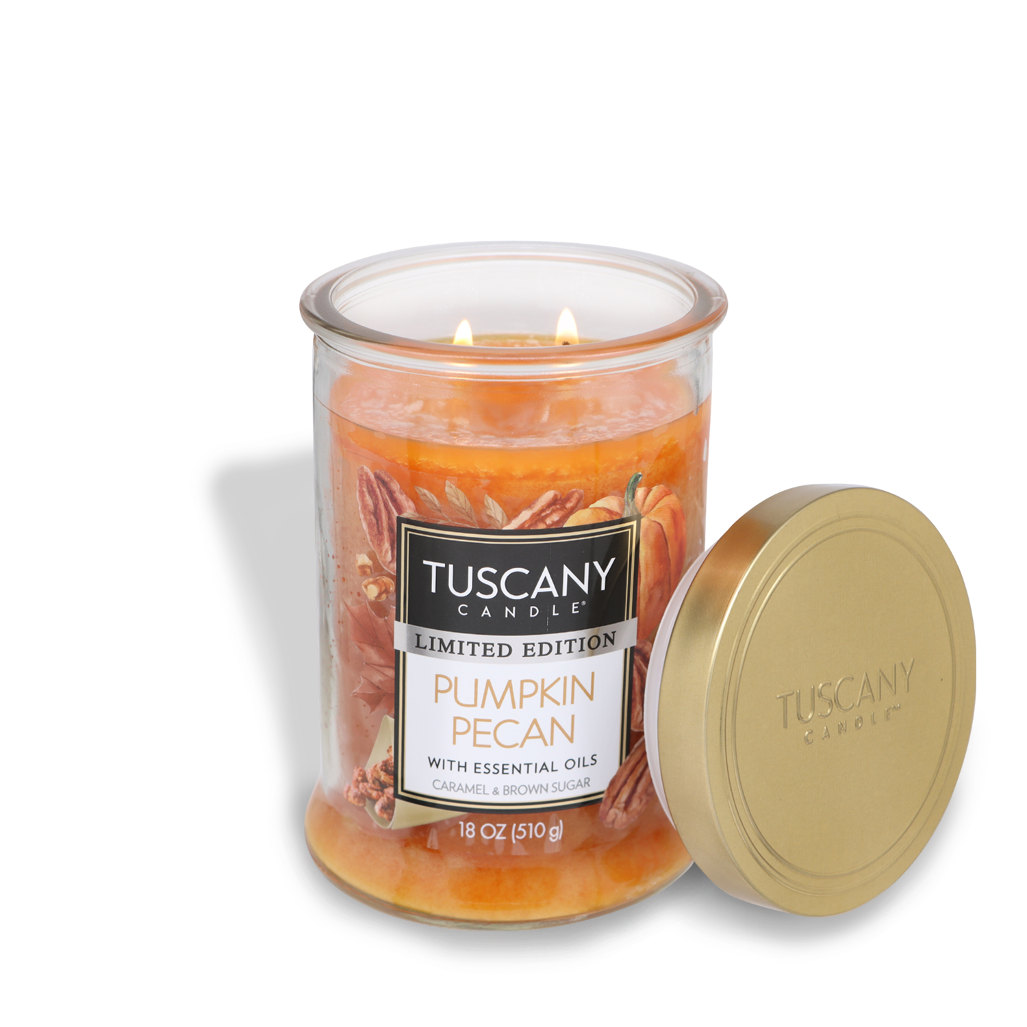 A lit Tuscany Candle® SEASONAL Pumpkin Pecan Long-Lasting Scented Jar Candle (18 oz) in a glass jar with an open gold lid. The candle label reads "Limited Edition Pumpkin Pecan with essential oils, caramel & brown sugar, 18 oz (510 g)." Enjoy the rich fragrance notes that these scented candles bring to your space.