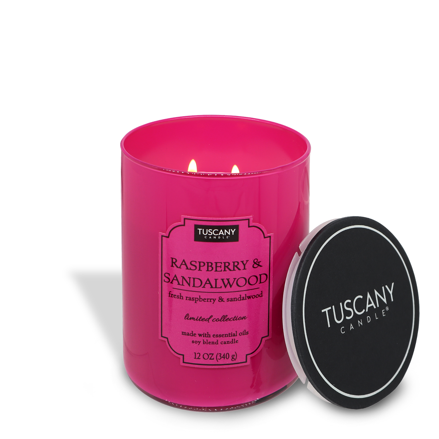 A lit Raspberry & Sandalwood (12 oz) scented candle in a pink glass container with a black lid placed beside it, labeled "Tuscany Candle® EVD.