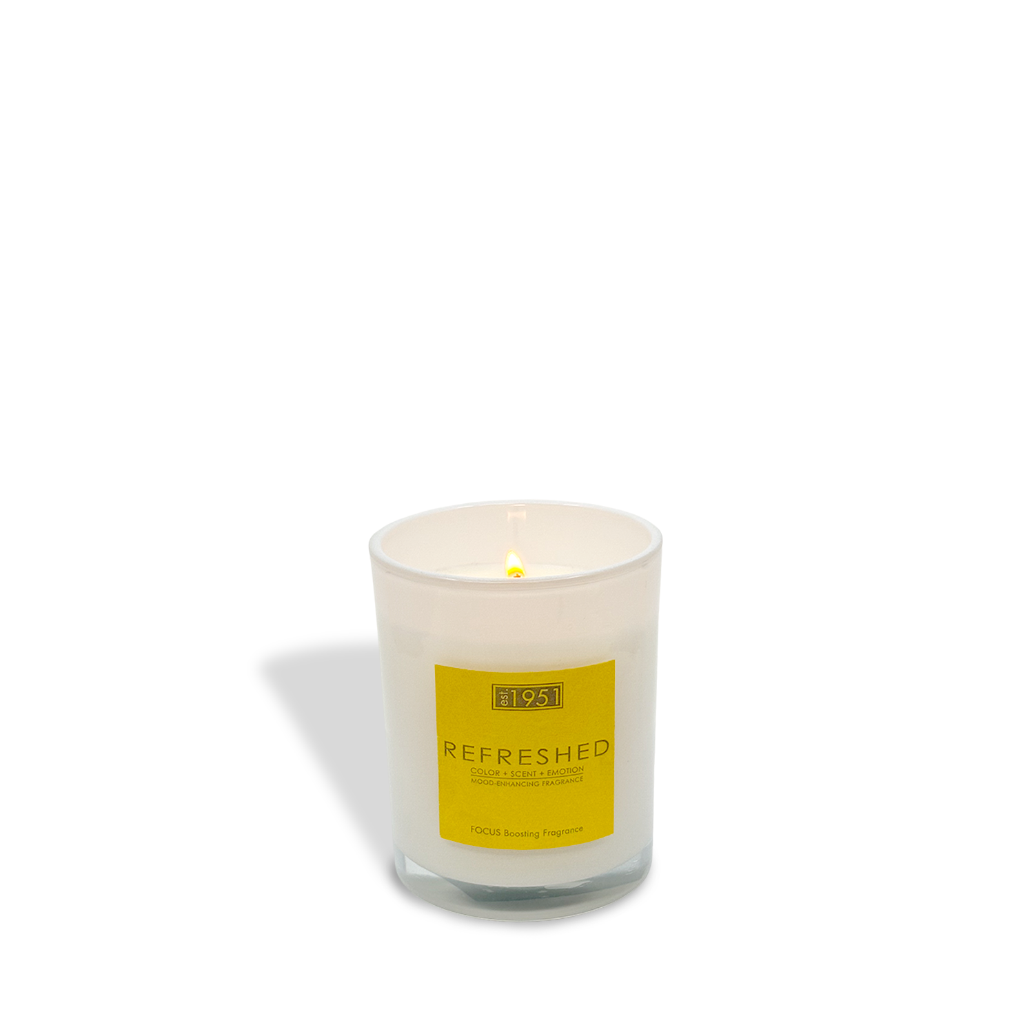 A lit est.1951 Refreshed (8oz) white citrus candle in a glass container with a yellow label reading "REFRESHED" and "100% Boosting Fragrance.