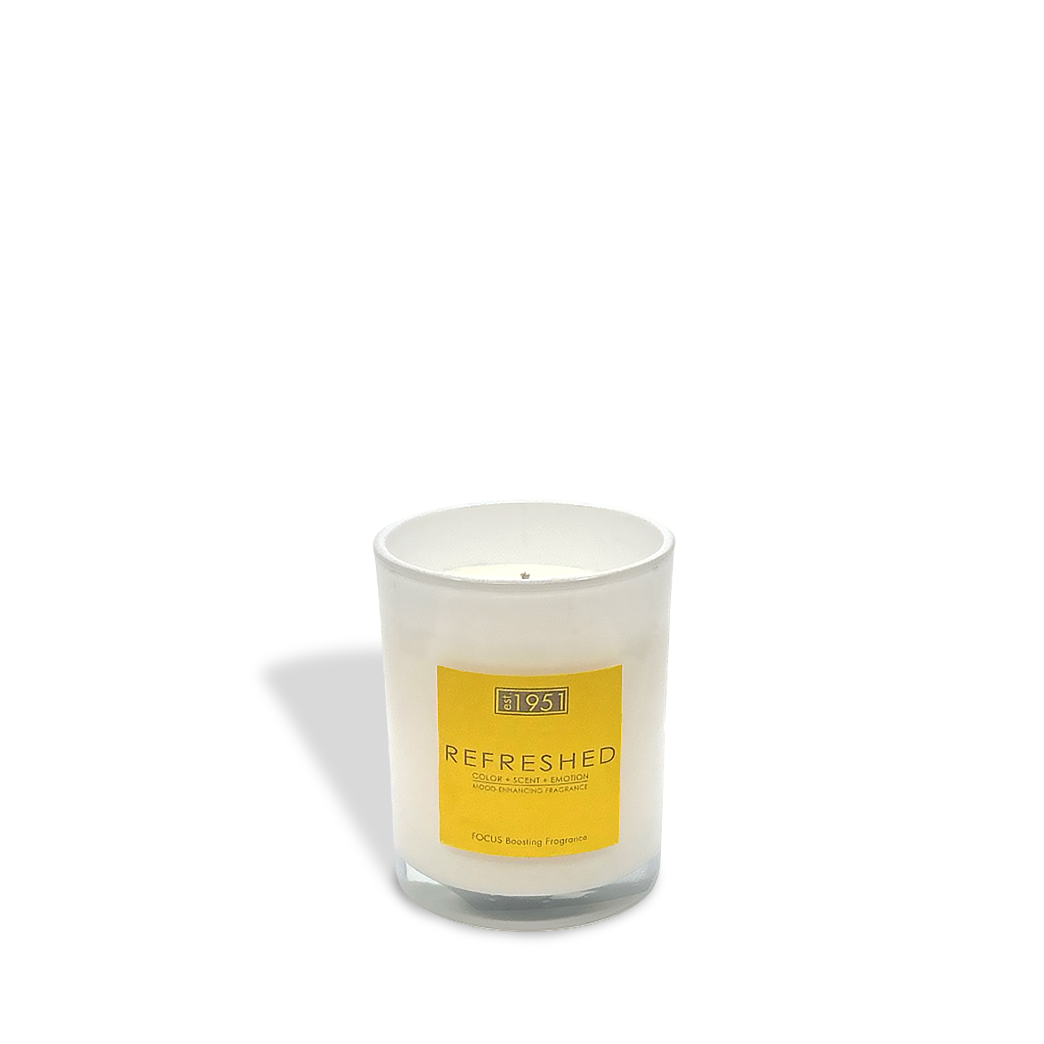 An est.1951 Refreshed (8oz) white glass candle jar with a yellow label rests on a white background, casting a gentle shadow—an uplifting citrus scent to brighten any space.