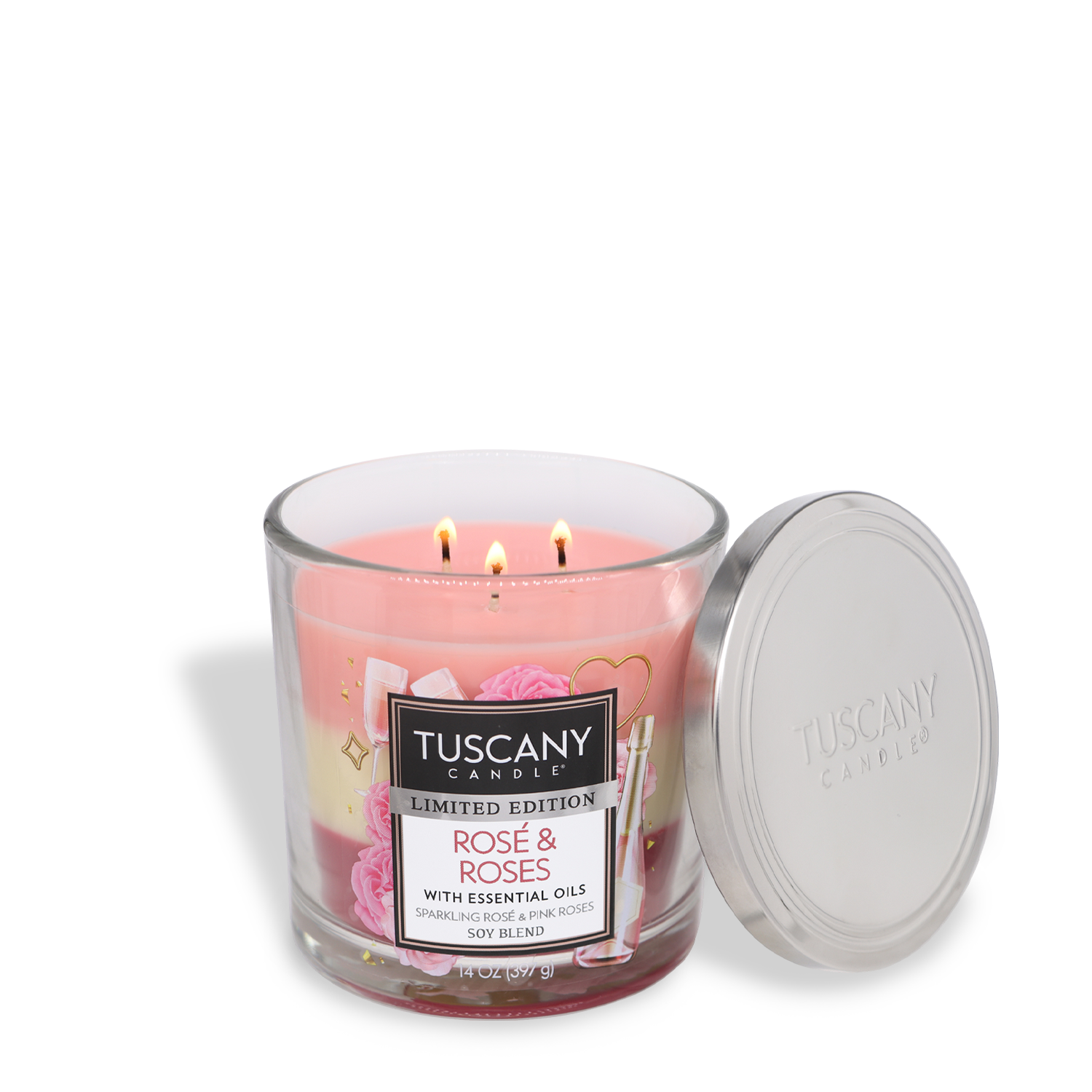 The scene features a glass jar candle, identified as the "Rosé & Roses: Floral Scented Valentine’s Day Candle (14 oz)" by Tuscany Candle® SEASONAL, with three wicks aglow and its silver lid placed open beside it. This romantic fragrance makes it the perfect Valentine’s Day candle, infusing the air with an enchanting rosé scent that enhances any peaceful evening.