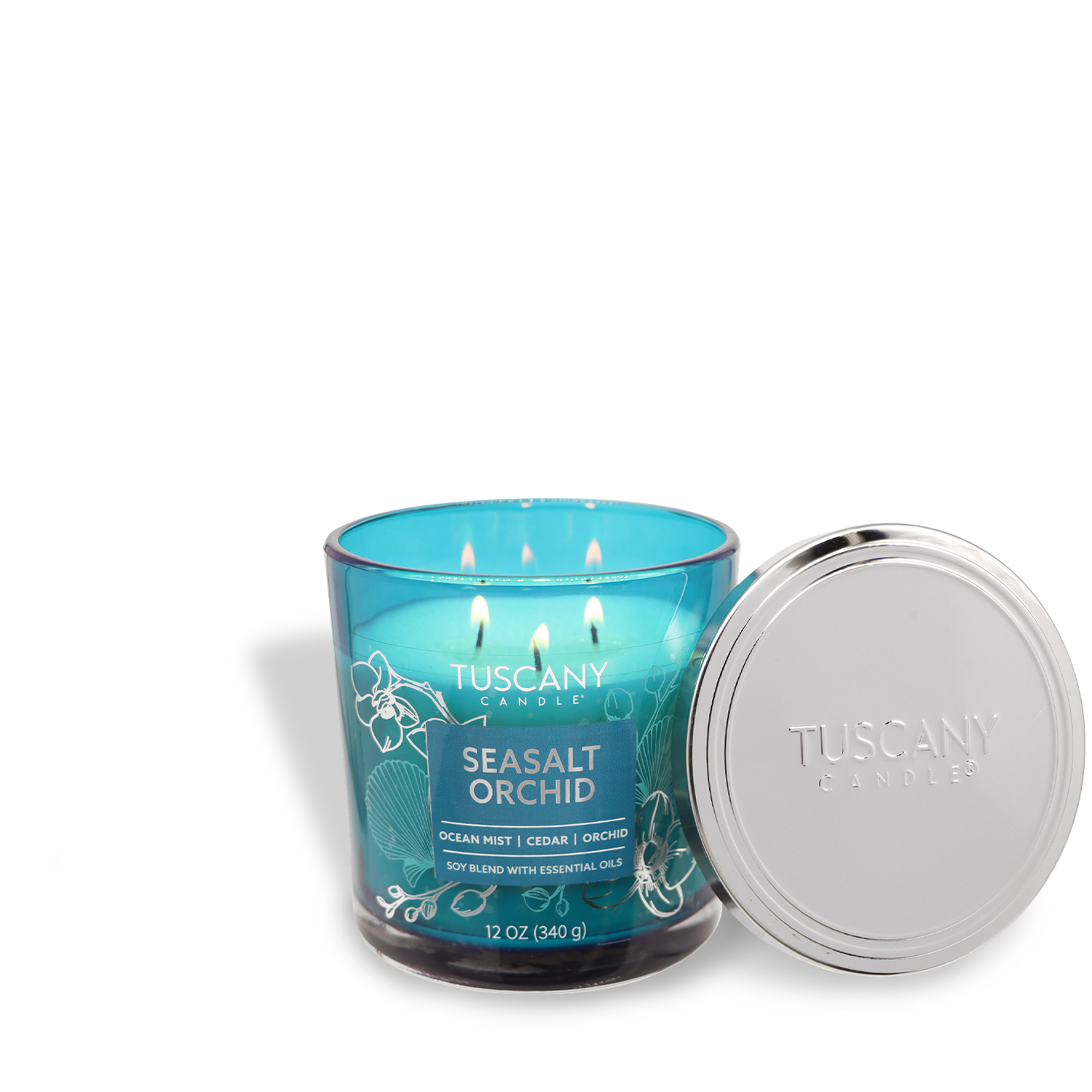 A lit Tuscany Candle® EVD from the Painters' Palette Collection, named "Seasalt Orchid," sits in a blue glass jar beside its silver lid.