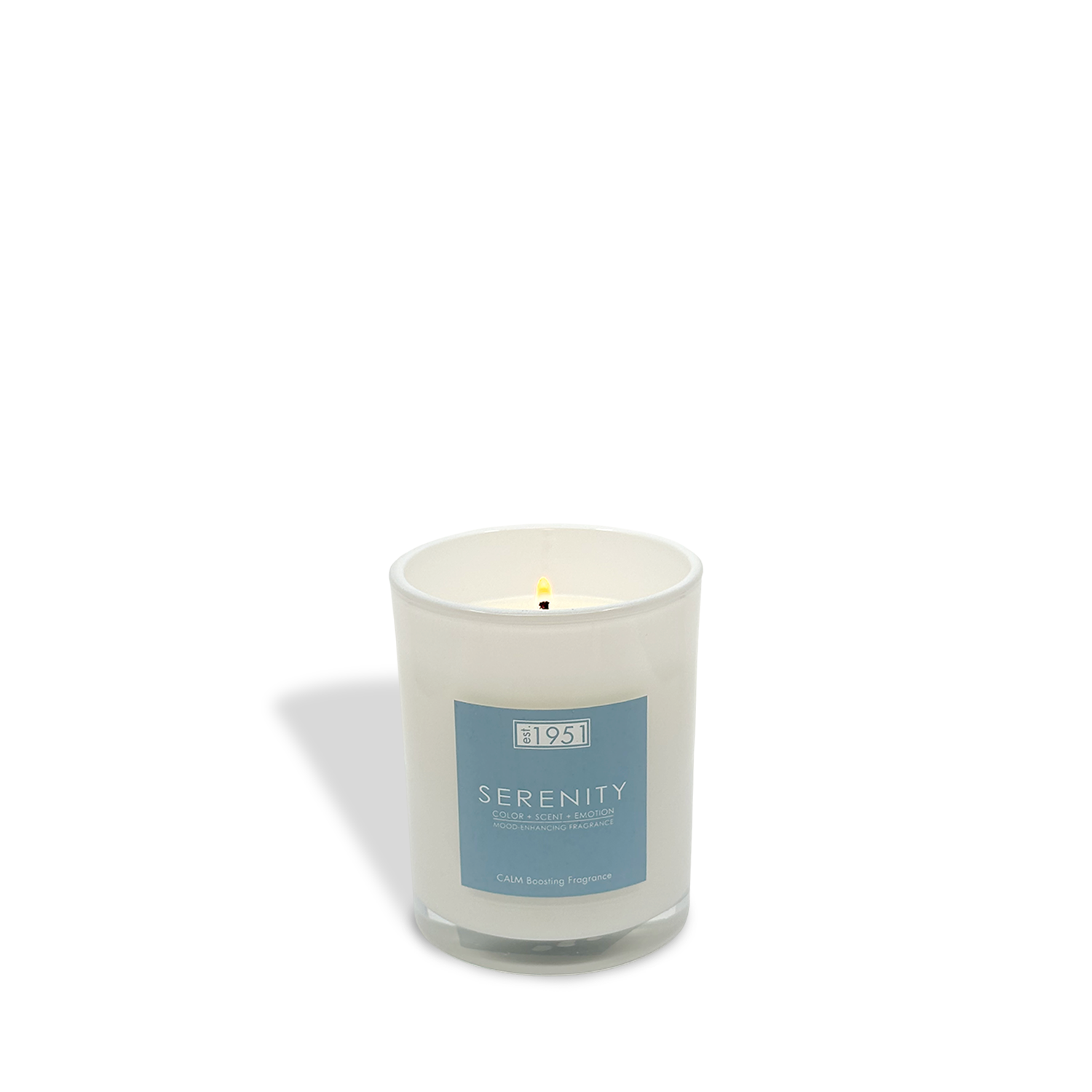 The est.1951 Serenity (8oz) white candle, in a glass holder with a blue label, sits on a white background—perfect for relaxing aromatherapy with its soothing sea salt scent.