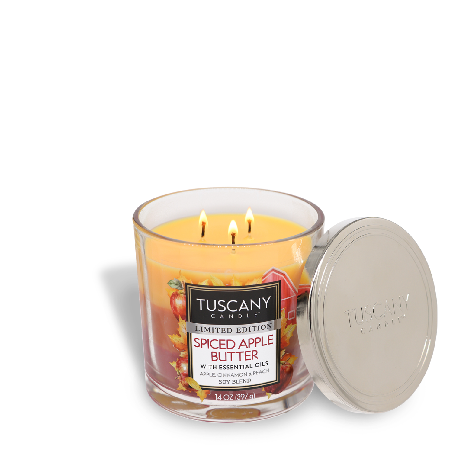 A Tuscany Candle® SEASONAL labeled "Spiced Apple Butter Long-Lasting Scented Jar Candle (14 oz)" is open with three lit wicks. The scented jar candle, made with premium satin wax, sits in a glass jar with a silver lid placed on the side, filling the room with warm fragrance notes of apple and spice.