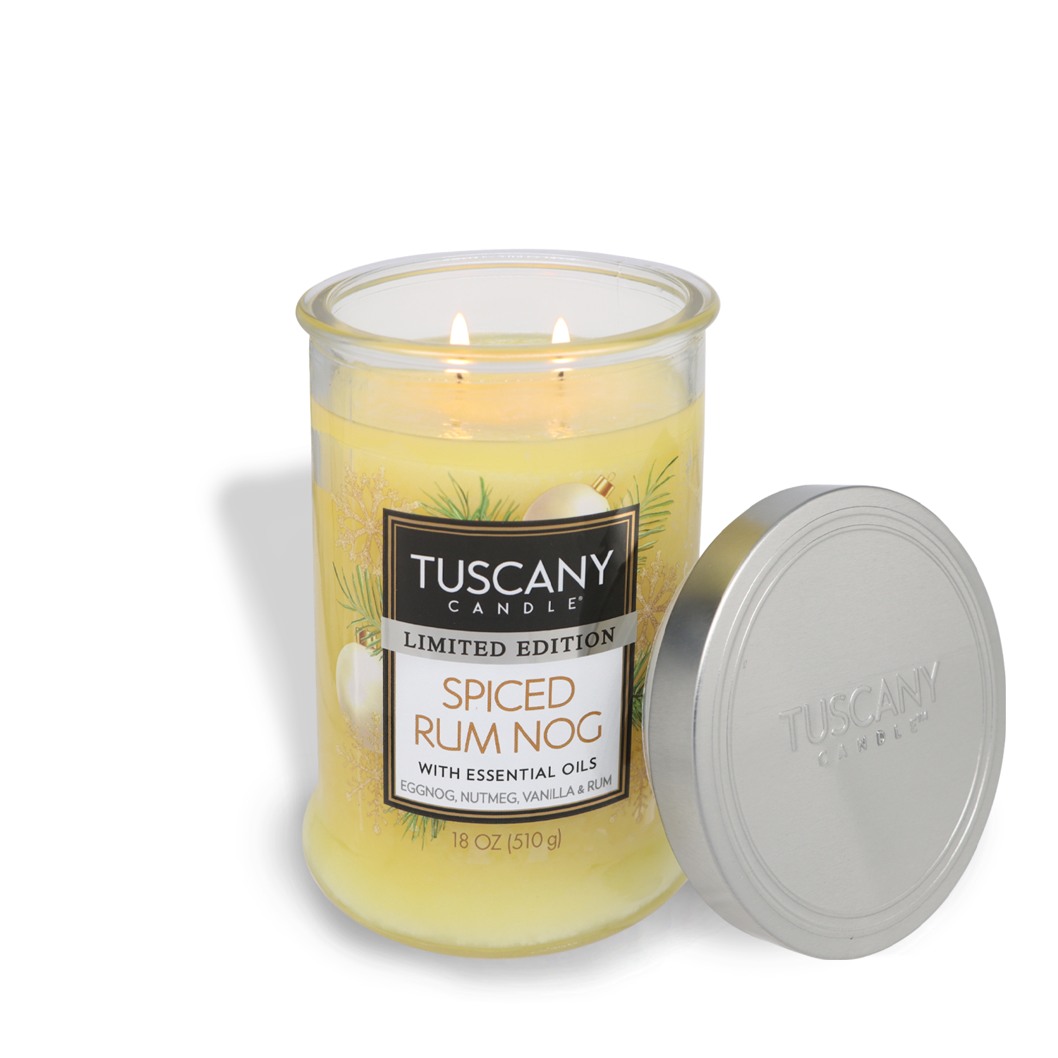 A lit Tuscany Candle® SEASONAL labeled "Spiced Rum Nog Long-Lasting Scented Jar Candle (18 oz)" with essential oils, featuring scents of eggnog, nutmeg, and vanilla rum. The yellow candle comes in an 18 oz glass jar with the lid off.