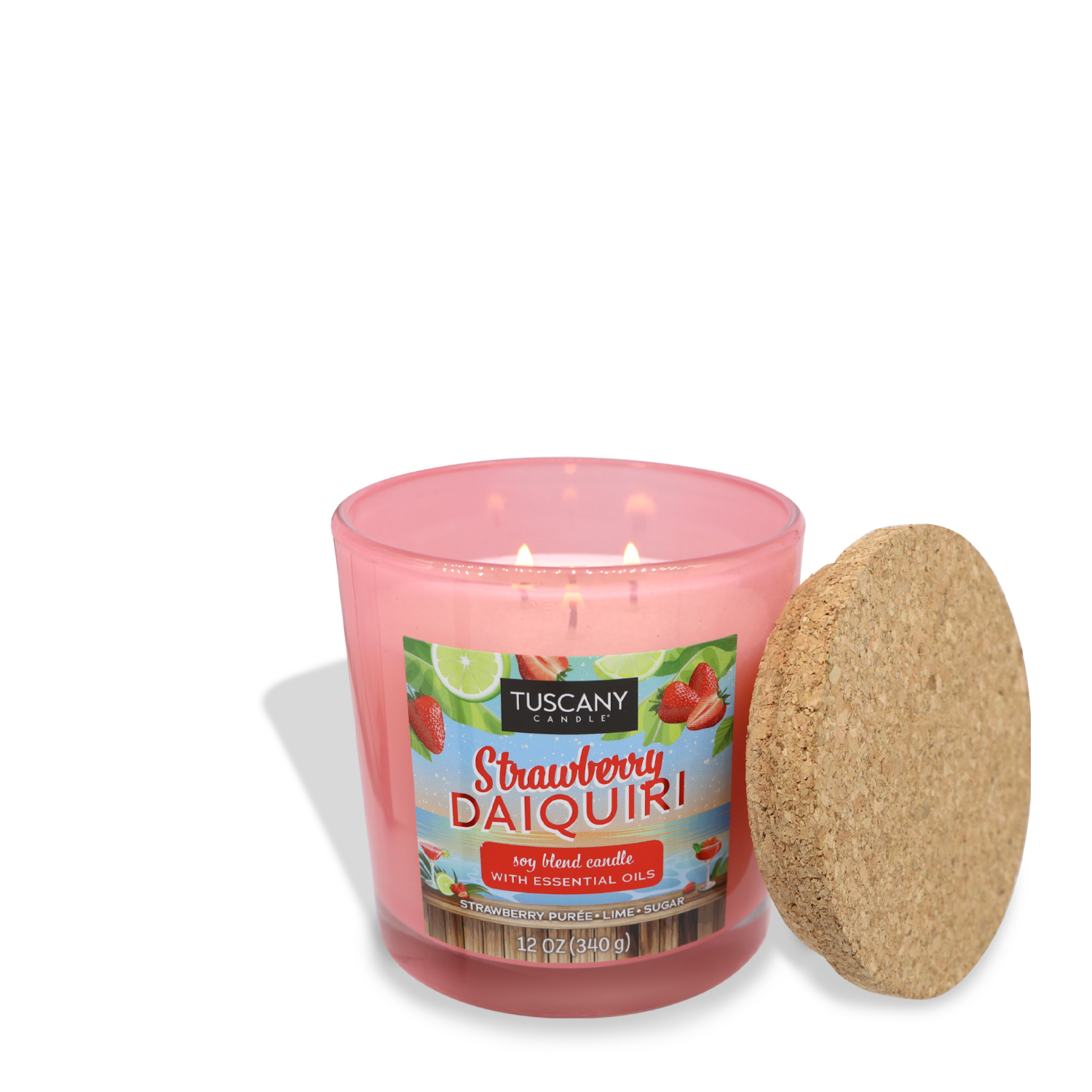 A pink Tuscany Candle® SEASONAL labeled "Strawberry Daiquiri (12 oz) – Sunset Beach Bar Collection" sits beside its cork lid. The candle is described as a soy blend with essential oils, capturing the tropical joy of sugared strawberries, and has a net weight of 12 oz (340 g).