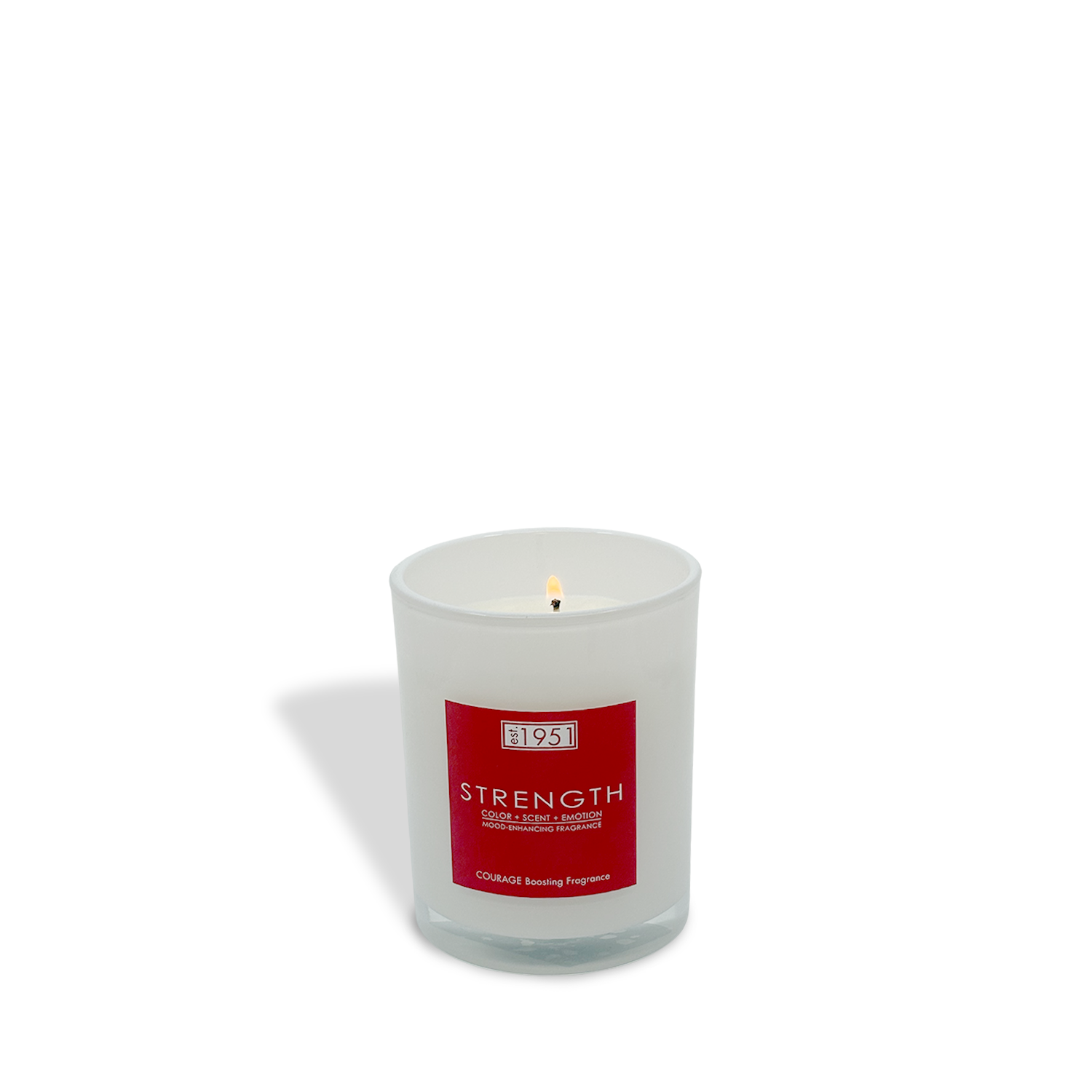 The est.1951 Strength (8oz) candle is a white glass candle with a lit flame and a red "STRENGTH" label, offering a courage-boosting fragrance for an energizing experience.