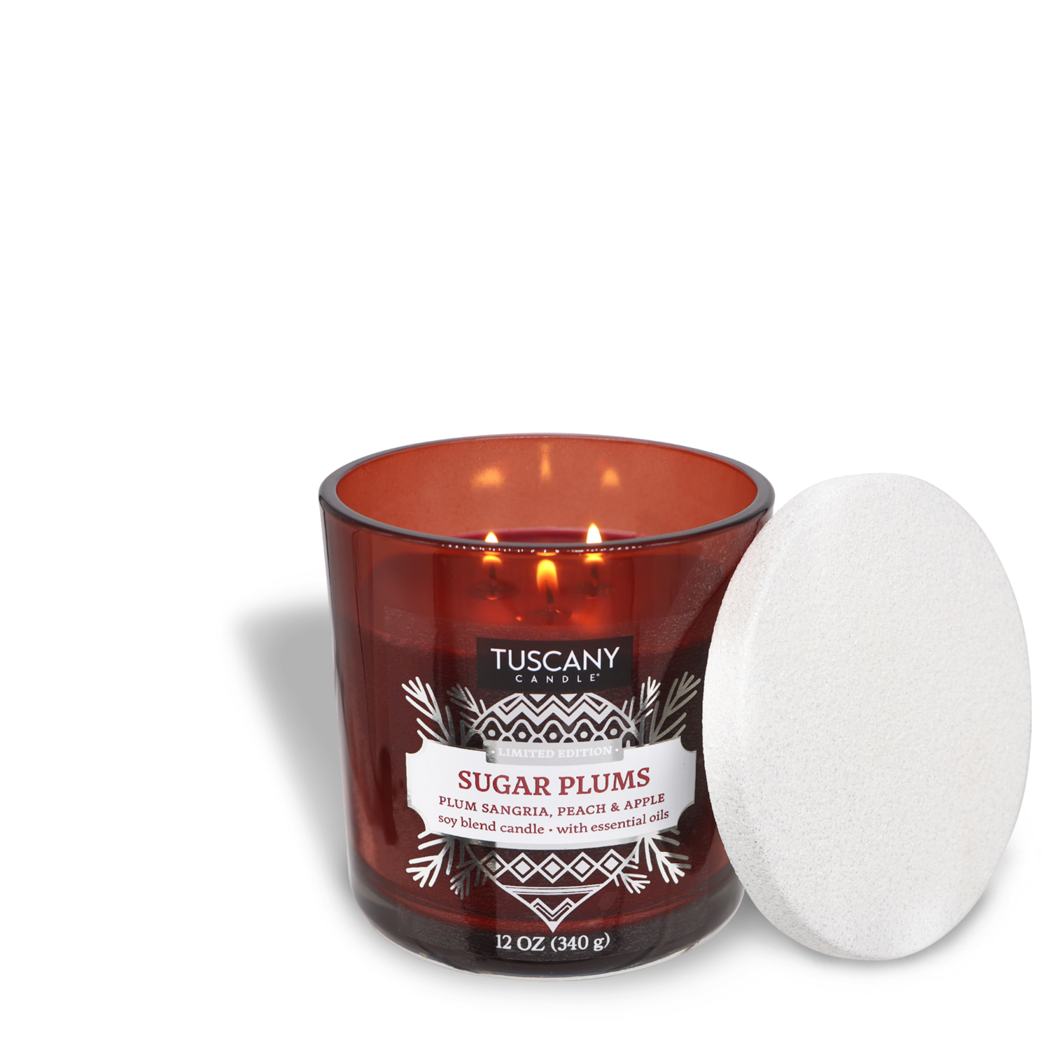 A lit Tuscany Candle® SEASONAL Sugar Plums Scented Jar Candle (12 oz) with the lid resting beside it. The candle emits a delightful scent of plum sangria, peach, and apple.