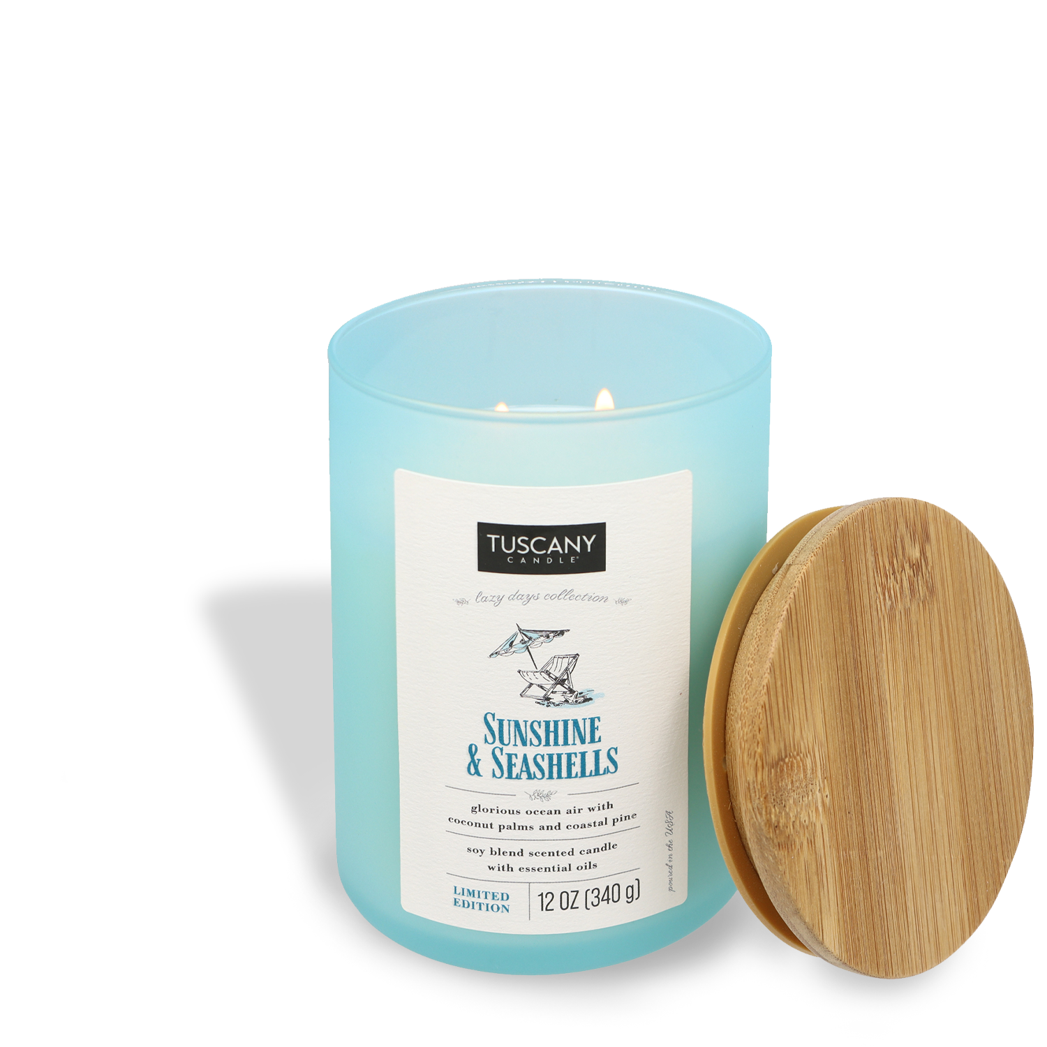 A Sunshine & Seashells (12 oz) scented candle with a wooden lid off to the side against a white background. Brand Name: Tuscany Candle® SEASONAL