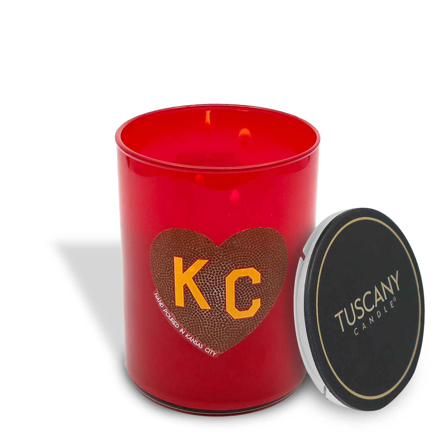 The 13 oz Tailgate Scented Football KC Heart Candle by Tuscany Candle x Charlie Hustle features a red jar with a heart and “KC”, plus a black lid, in this exclusive collaboration.