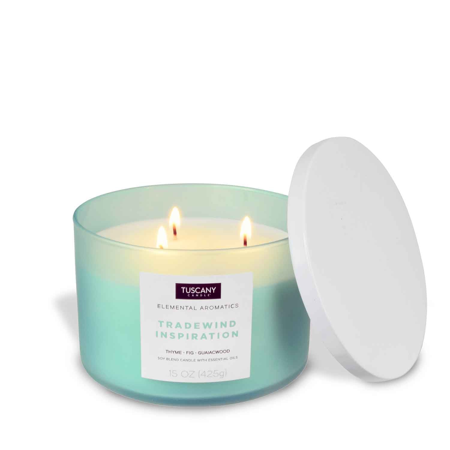 A Tradewind Inspiration scented candle with three candles in a white container.