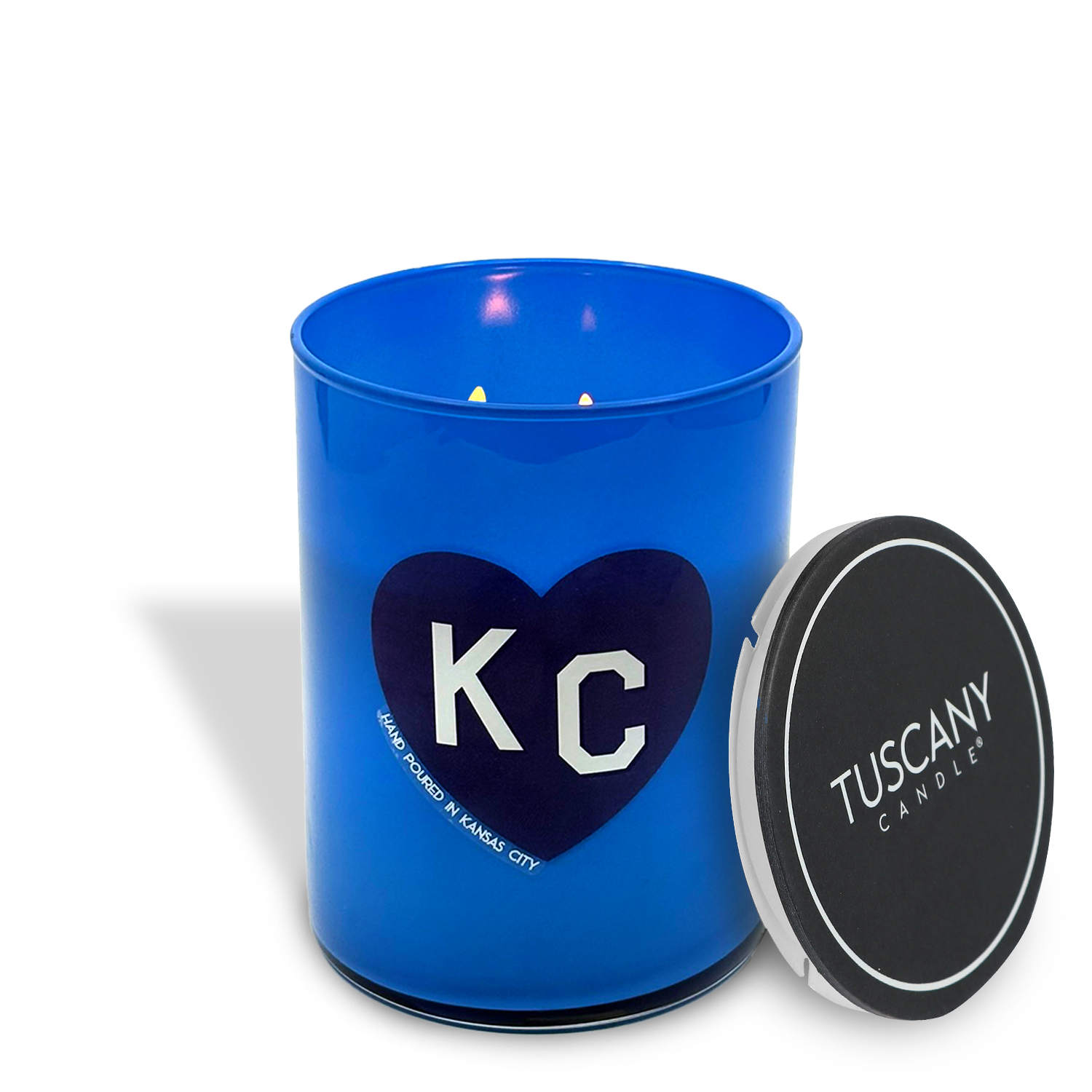 The Vanilla Bean Scented Blue KC Heart Candle (13 oz) by Tuscany Candle x Charlie Hustle features a sweet vanilla fragrance in a blue jar with heart and "KC" on the front—a perfect collaboration piece.