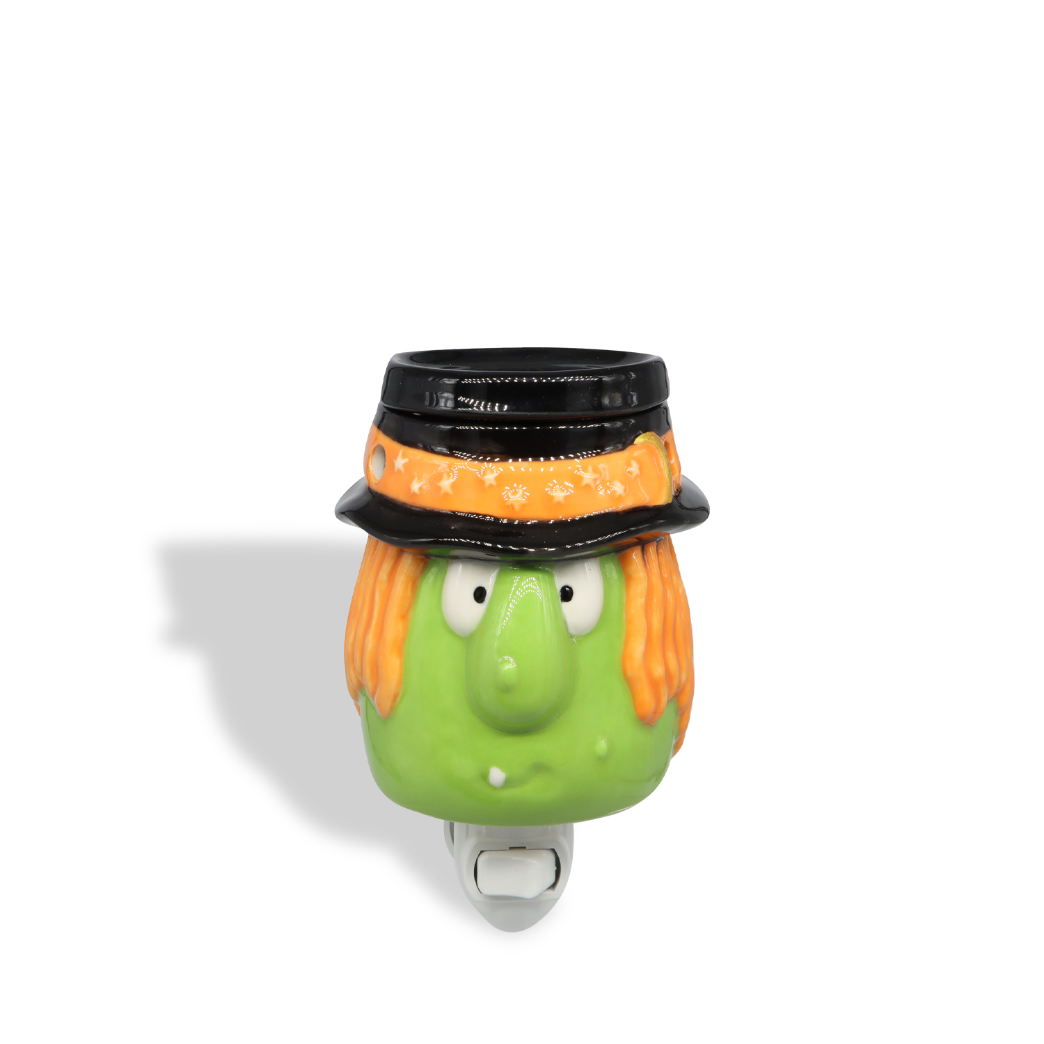The Tuscany Candle® SEASONAL Witch Outlet Wax Melt Warmer features a green-faced witch with orange hair, black hat, and yellow headband—an ideal Halloween décor piece for melting your favorite wax melts.