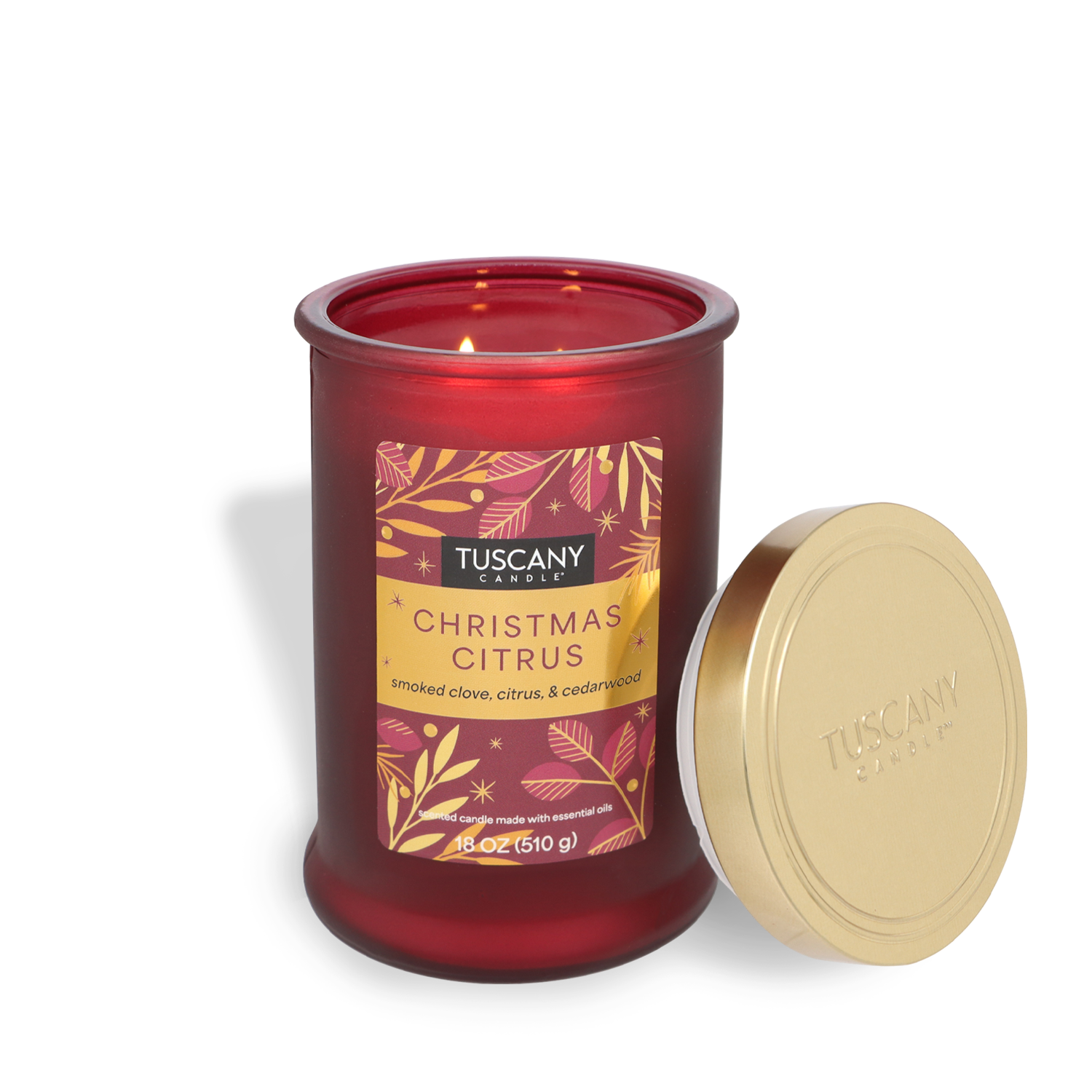 Christmas Citrus Scented Jar Candle (18 oz) by Tuscany Candle® SEASONAL with the gold lid off and the wick lit.