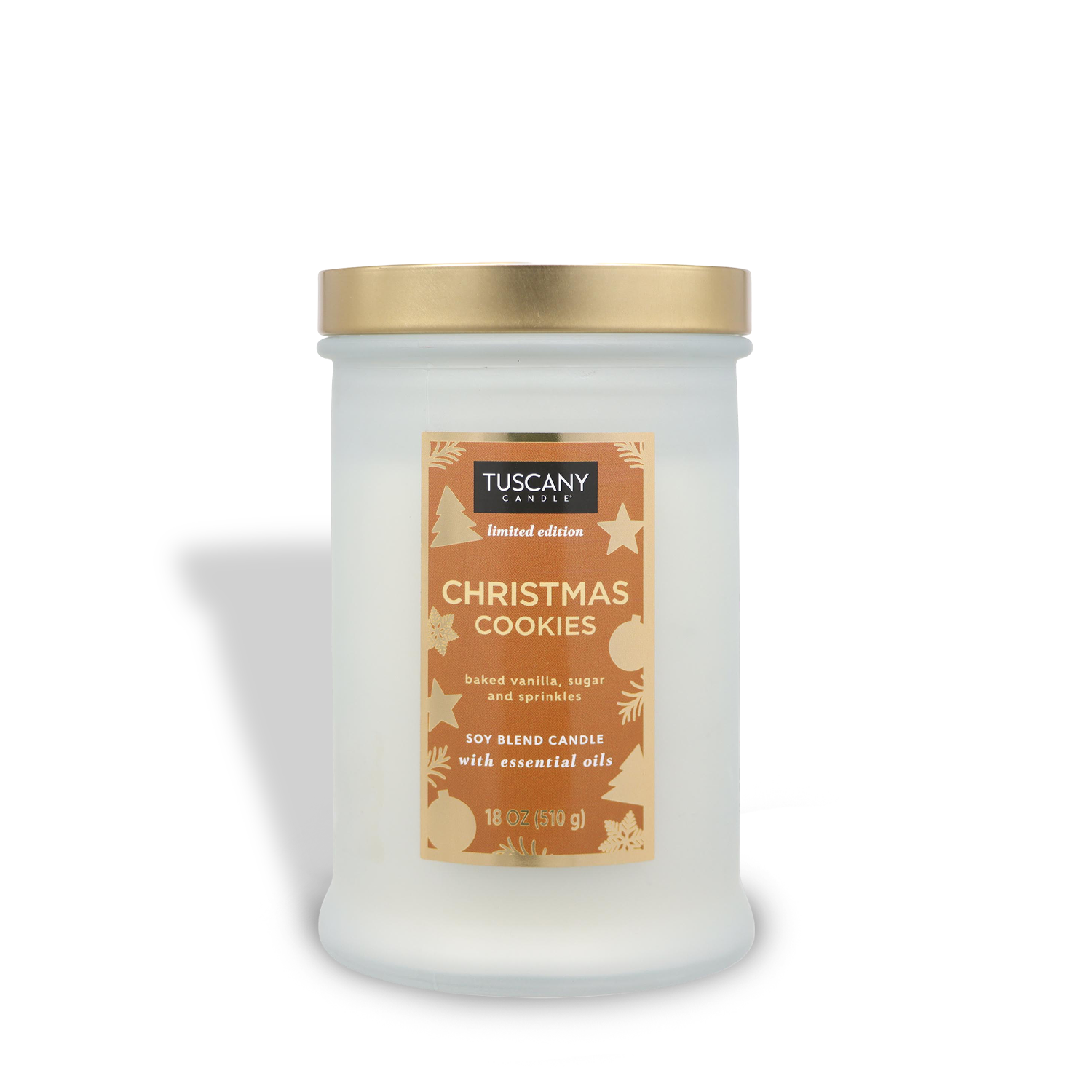 An 18 oz white jar candle from the Winter Reverie Collection by Tuscany Candle® SEASONAL, labeled "Christmas Cookies," with a gold lid. The label highlights a soy blend with essential oils and scents of baked vanilla, sugar, and sprinkles.