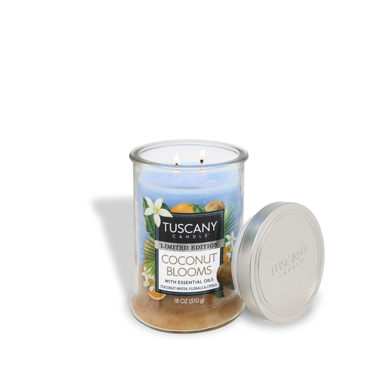 A lit Tuscany Candle® SEASONAL Coconut Blooms: Tropical Scented Spring Candle (18 oz) in a glass jar sits beside a silver lid.