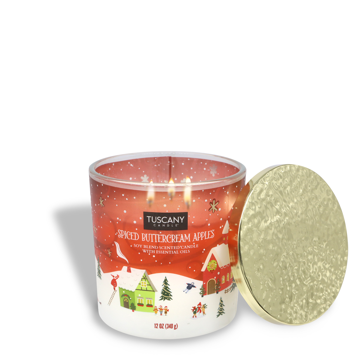 A Tuscany Candle® SEASONAL product, the "Spiced Buttercream Apples Scented Jar Candle," features a winter village scene on the jar with a textured gold lid and weighs 12 oz (340 g).