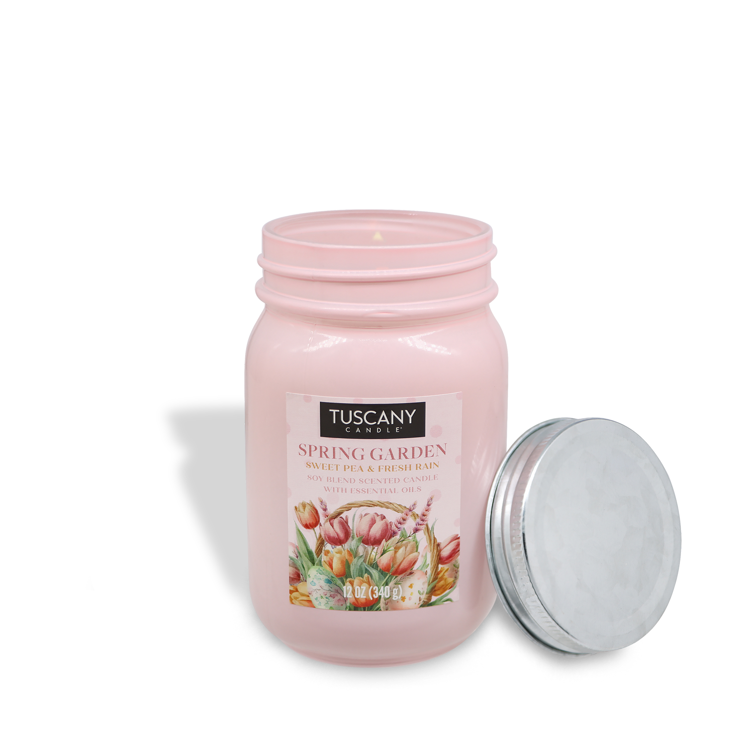 The pink jar candle, "Spring Garden: Rain & Sweet Pea Scented Easter Candle" by Tuscany Candle® SEASONAL, comes with a silver lid placed beside it.