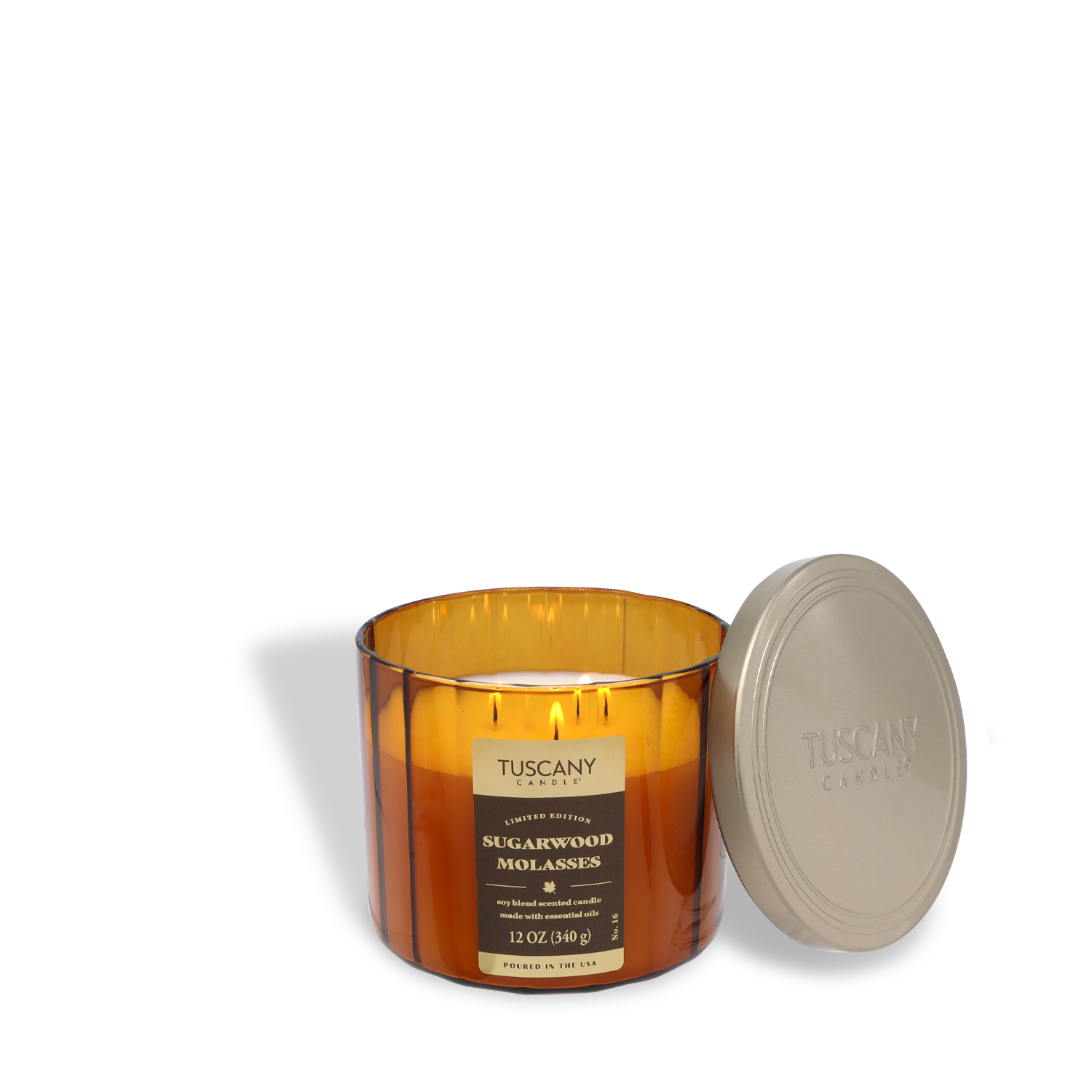 A Tuscany Candle® SEASONAL 12 oz brown glass candle, labeled "Sugarwood Molasses: Maple & Chestnut Scented Fall Candle," sits with its lid off and placed beside it.