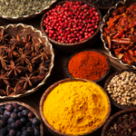 Load image into Gallery viewer, A still life photo of powdered cinnamon, star anise, and other spices which provide fragrance  note for Tuscany Candle&#39;s &quot;Cinnamon&quot; scented candle
