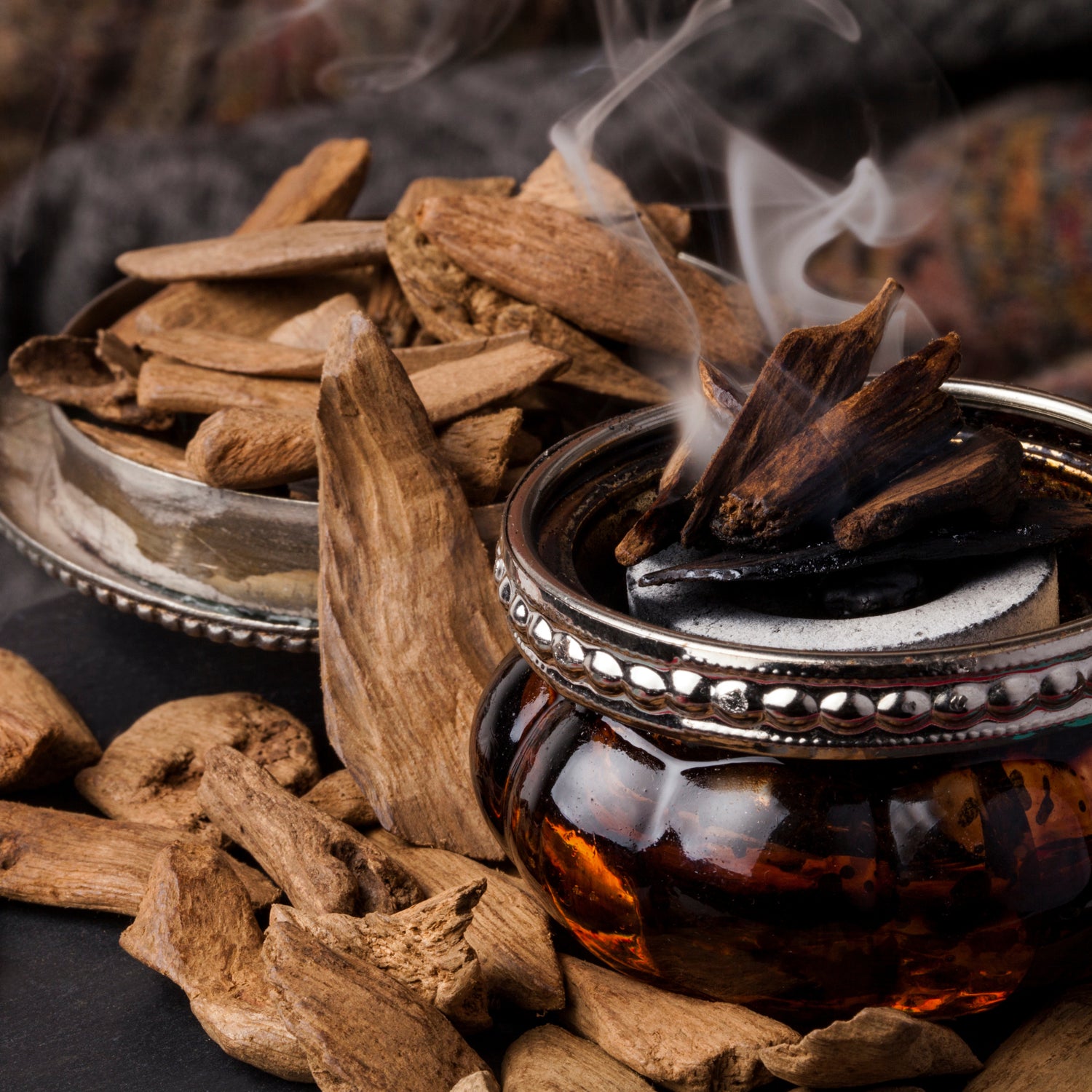 A photo of some of the components of the masculine incense fragrance notes in the "Amber Oud" scented candle from Tuscany candle